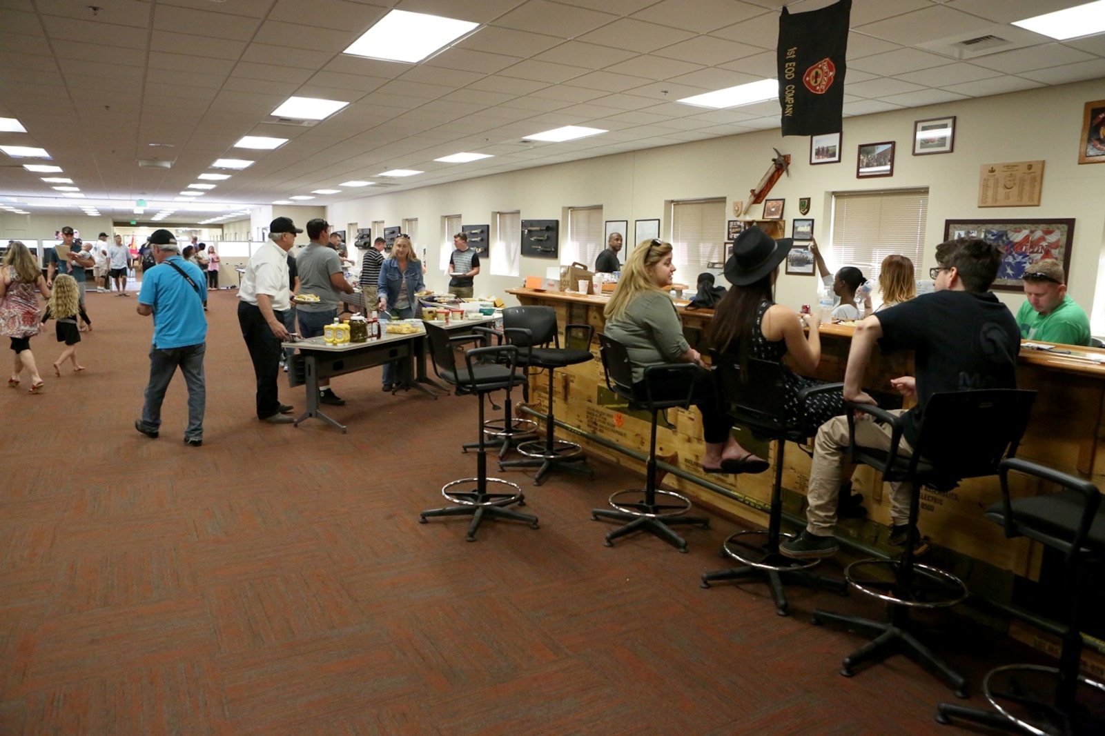 Marines and their families gather for food during a family day hosted by 1st Explosive Ordnance Disposal Company, 7th Engineer Support Battalion, 1st Marine Logistics Group, aboard Camp Pendleton, Calif., April 23, 2016. Marines with 1st EOD Co. hosted the Viper Club of Southern California for the day as a part of their celebration, which included food, family activities, and a line-up of show cars. (U.S. Marine Corps photo by Cpl. Carson Gramley/released)