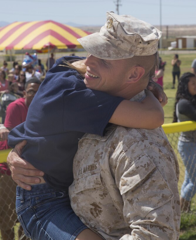 Lt. Col. David Hart, commanding officer, 1st Battalion, 7th Marine Regiment, embraces his daughter during the battalion’s homecoming at Del Valle Field April 23, 2016. 1/7 was deployed as part of Special Purpose Marine Air Ground Task Force-Crisis Response-Central Command 16.1. (Official Marine Corps photo by Cpl. Medina Ayala-Lo/Released)