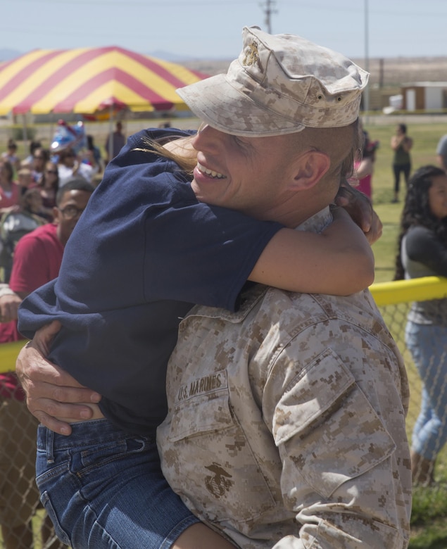 Lt. Col. David Hart, commanding officer, 1st Battalion, 7th Marine Regiment, embraces his daughter during the battalion’s homecoming at Del Valle Field April 23, 2016. 1/7 was deployed as part of Special Purpose Marine Air Ground Task Force-Crisis Response-Central Command 16.1. (Official Marine Corps photo by Cpl. Medina Ayala-Lo/Released)