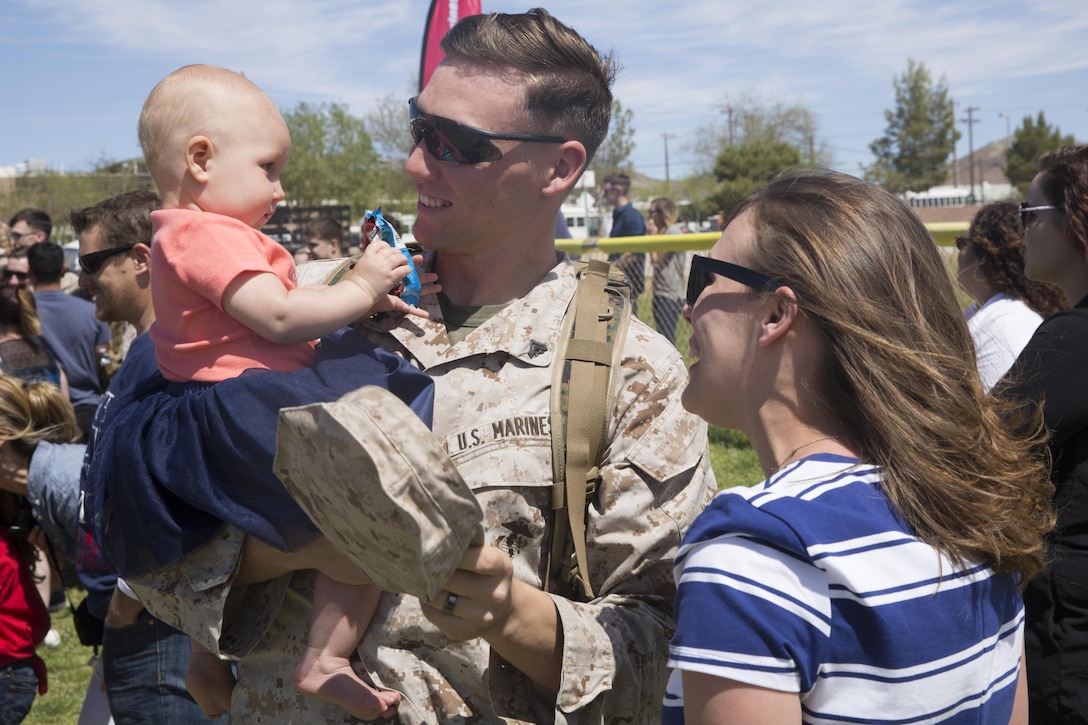 Cpl. John Sherriffs, rifleman, 1st Battalion, 7th Marine Regiment, greets his 7-month-old daughter, April, during the battalion’s homecoming at Del Valle Field April 23, 2016. 1/7 was deployed as part of Special Purpose Marine Air Ground Task Force-Crisis Response-Central Command 16.1. (Official Marine Corps photo by Cpl. Medina Ayala-Lo/Released)