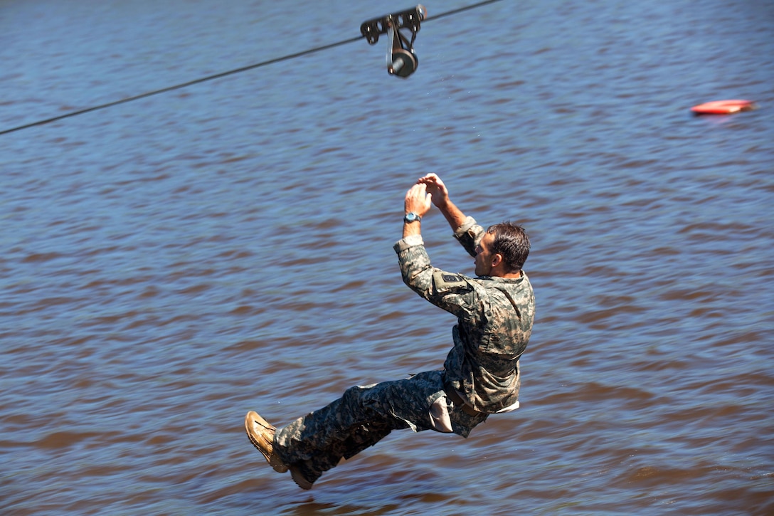 Army 2nd Lt. Zachary Hayes releases his zip line on Victory Pond during the Best Ranger Competition 2016 at Fort Benning, Ga., April 17, 2016. Hayes is assigned to the 82nd Airborne Division. Army photo by Sgt. Austin Berner
