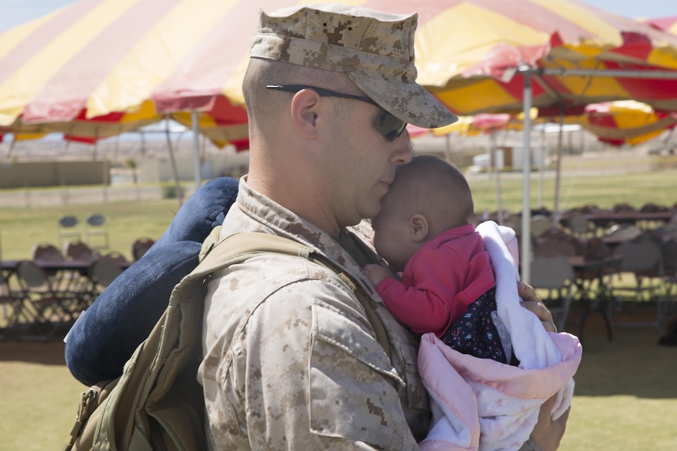 Staff Sgt. Darrell Wills, data network specialist, 1st Battalion, 7th Marine Regiment, greets his 2-month-old daughter, Katie, during the battalion’s homecoming at Del Valle Field April 23, 2016. 1/7 was deployed as part of Special Purpose Marine Air Ground Task Force-Crisis Response-Central Command 16.1. (Official Marine Corps photo by Cpl. Medina Ayala-Lo/Released)