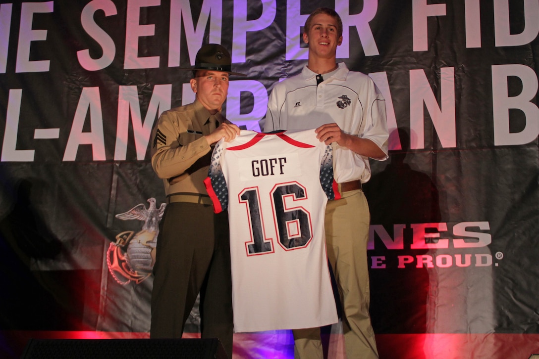 Drill instructor Sgt. Matthew Lee presents Jared Goff with his Semper Fidelis All-American Bowl jersey at a banquet Jan. 3, 2013. Goff was selected as the number one overall player in the 2016 NFL Draft by the Los Angeles Rams. 
