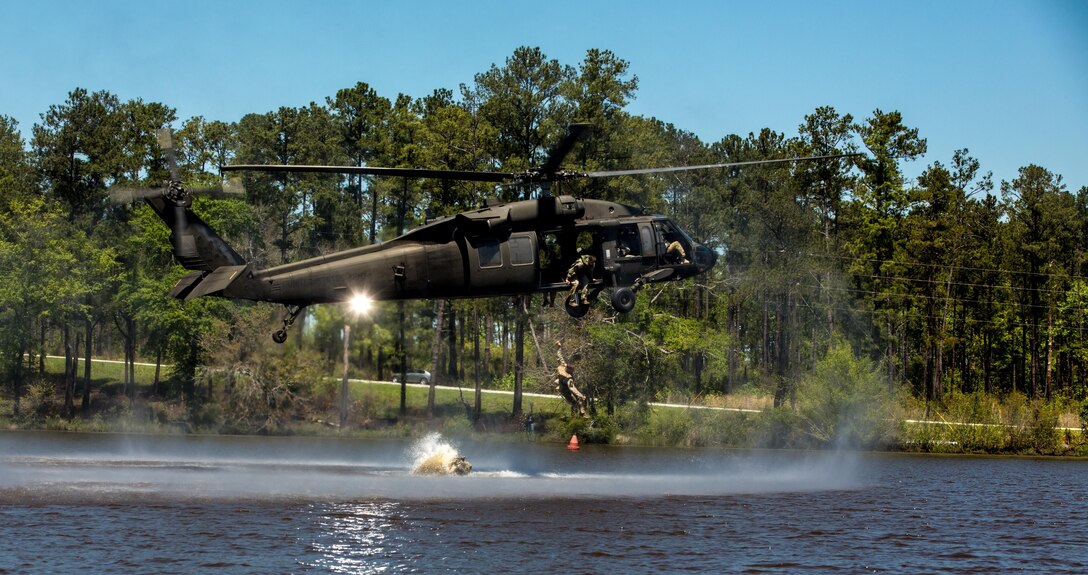 Army Capt. Mark Gaudet and 1st Lt. Timothy Nelson drop into a pond from a UH-60 Black Hawk helicopter during the Best Ranger Competition 2016 at Fort Benning, Ga., April 17, 2016. Gaudet and Nelson are assigned to the 1st Infantry Division. Army photo by Spc. Steven Hitchcock