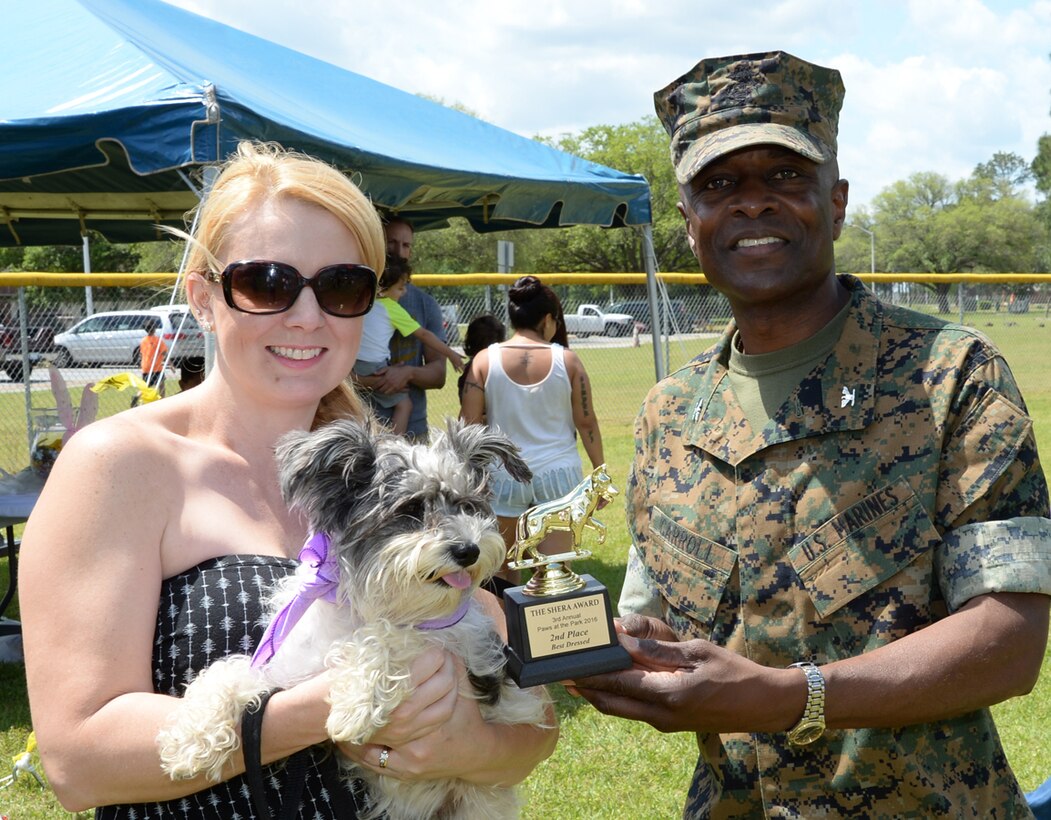 Angel, a Miniature Schnauzer held by her owner Amy Lawson, places second in the best dressed competition at the Paws at the Park event aboard Marine Corps Logistics Base Albany’s Crouch Field, April 23. Col. James C. Carroll III, commanding officer, MCLB Albany, presented the awards.
