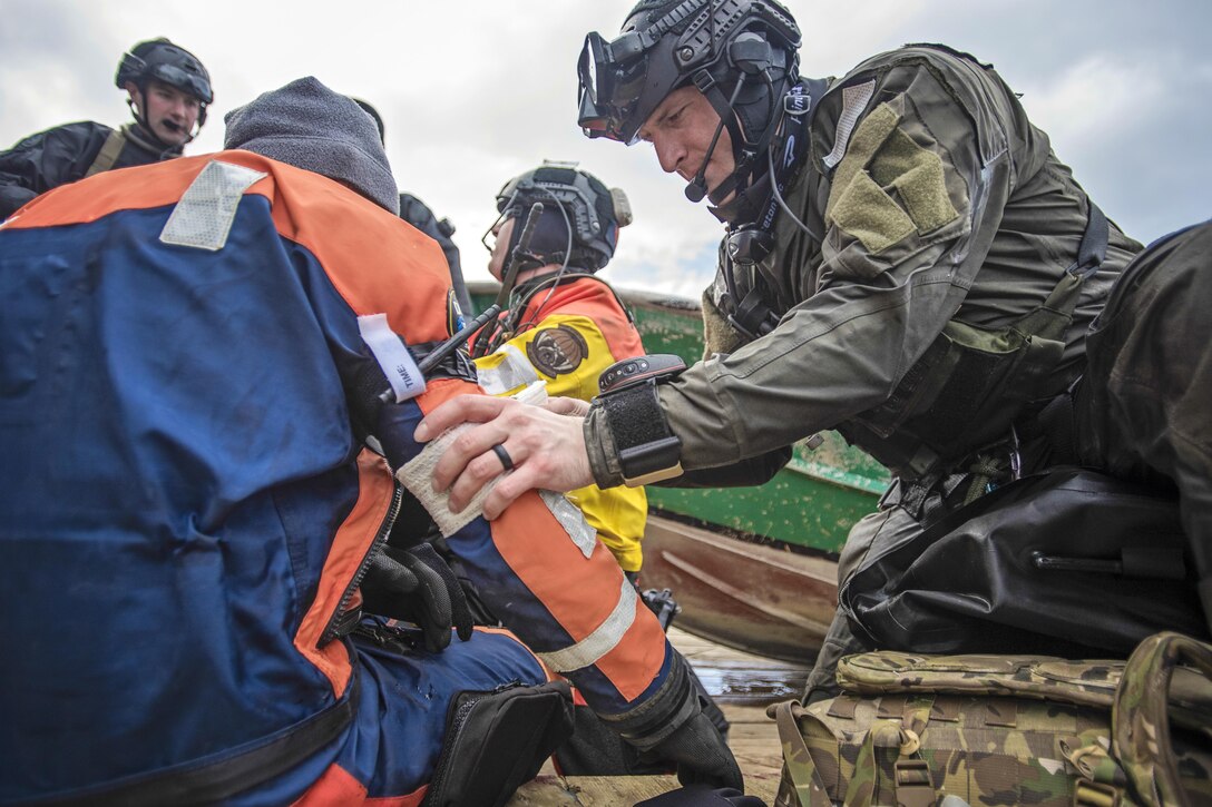 Airmen take part in a simulated casualty evacuation training exercise off the coast of Homer, Alaska, April 27, 2016. The scenario involved an injured member of a fishing vessel who required immediate treatment and extraction from the boat. The airmen are assigned to the Alaska Air National Guard. Alaska National Guard photo by Air Force Staff Sgt. Edward Eagerton