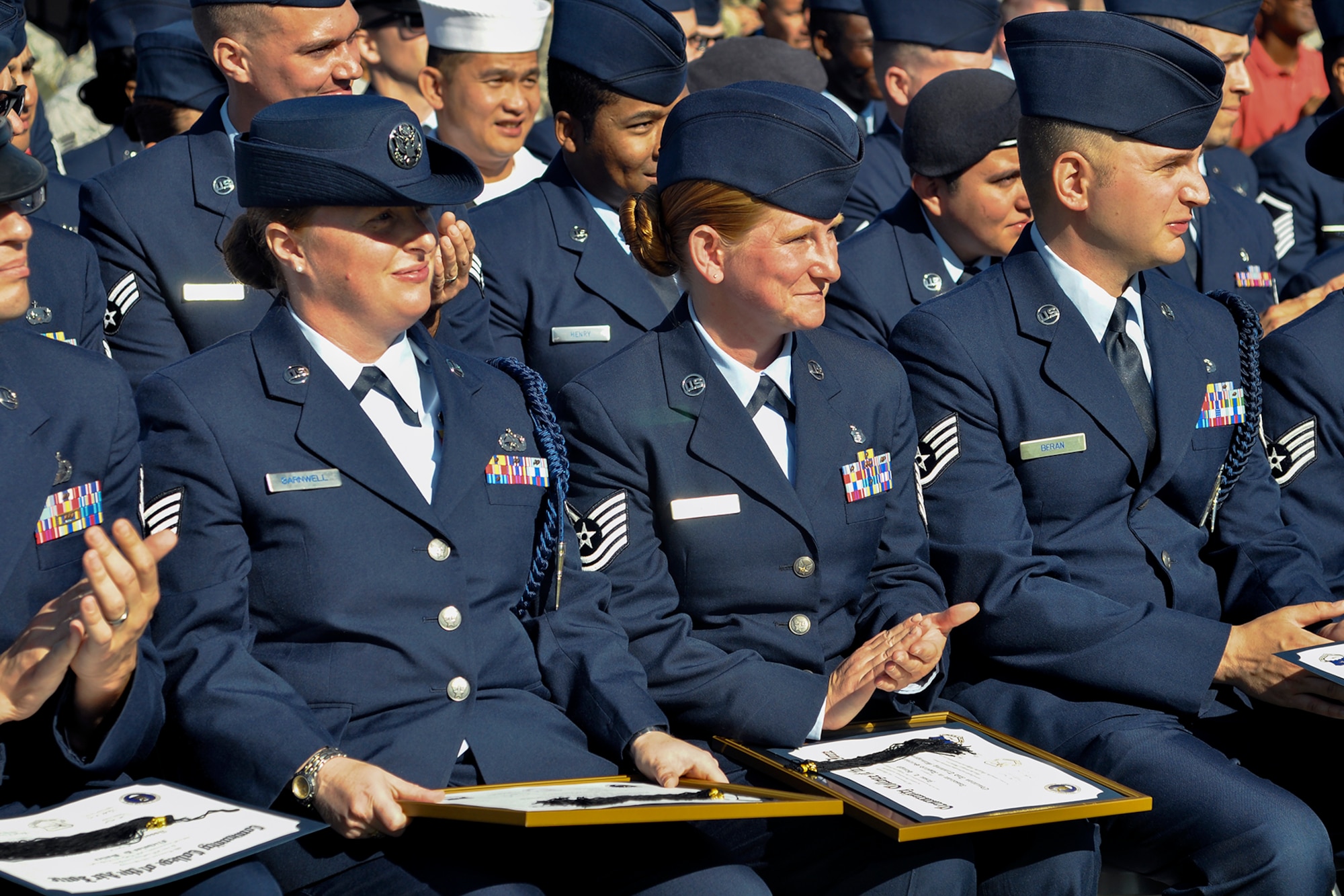 U.S. Air Force Staff Sgt. Cassie Barnwell, 315th Training Squadron, and Tech. Sgt. Jessi Baugh, 17th Medical Support Squadron, sit down after receiving the Air Force Association Pitsenbarger Award at the parade field on Goodfellow Air Force Base, Texas, April 27, 2016. The Pitsenbarger Award is a one-time grant of $400 provided to selected top Air Force enlisted personnel graduating from the CCAF who plan to pursue a bachelor’s degree. (U.S. Air Force photo by 2nd Lt. Tisha Wilkerson/Released)