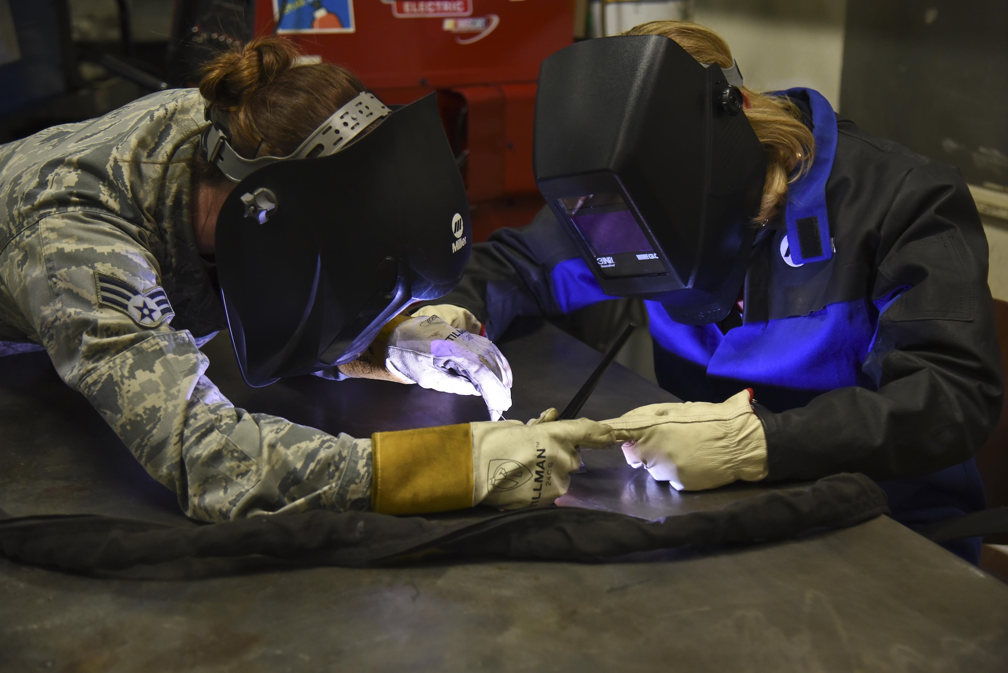 Air Force Secretary Deborah Lee James, right, completes a welding project April 27, 2016, at Fairchild Air Force Base, Wash., under the supervision of Senior Airman Mary Cannon, a 92nd Maintenance Squadron metals technology journeyman. James visited the base to familiarize herself with the missions of the 92nd and 141st Air Refueling Wings and 336th Training Group. (U.S. Air Force photo/Airman 1st Class Mackenzie Richardson) 