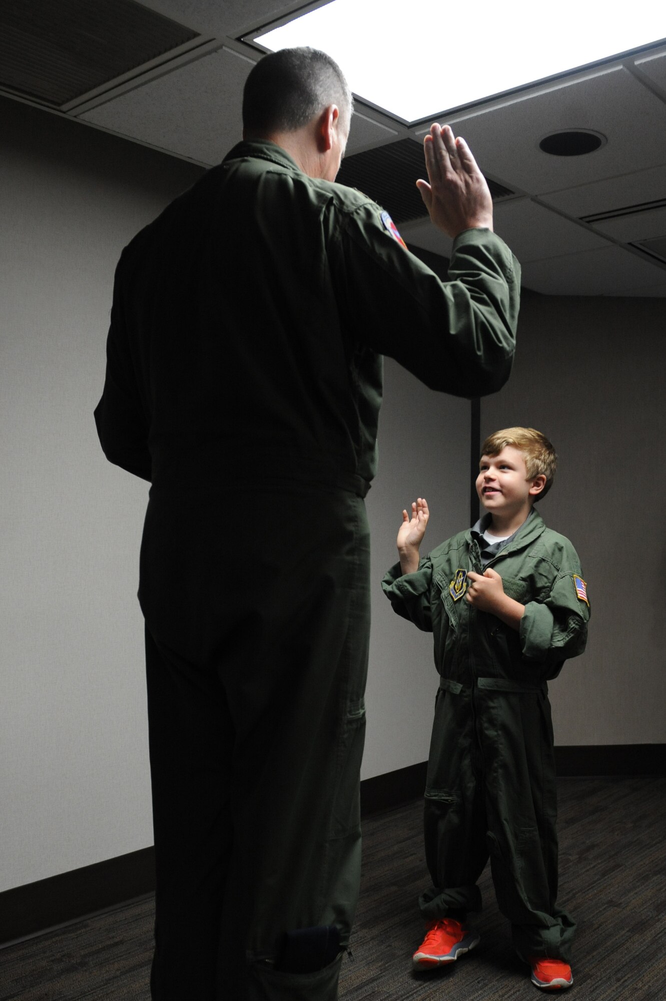Jon Bryant “JB” Orso of Mobile, Ala., is sworn in as an honorary Air Force Reserve second lieutenant by Maj. Jerry Rutland, 403rd Wing chief pilot, at the 53rd Weather Reconnaissance Squadron building during the 403rd Wing’s first Pilot for a Day event April 26, 2016, Keesler Air Force Base, Miss. Orso is in remission after receiving treatment for Acute Lymphoblastic Leukemia. Pilot for a Day is a community outreach program for children who live with a chronic or life-threatening disease or illness. (U.S. Air Force photo by Kemberly Groue)