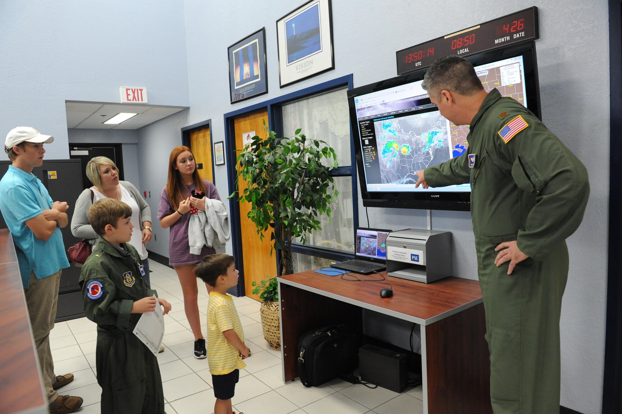 Maj. Jerry Rutland, 403rd Wing chief pilot, provides a weather update to Jon Bryant “JB” Orso at base operations during the 403rd Wing’s first Pilot for a Day event April 26, 2016, Keesler Air Force Base, Miss. Orso, who served as an honorary Air Force Reserve second lieutenant, is in remission after receiving treatment for Acute Lymphoblastic Leukemia. Pilot for a Day is a community outreach program for children who live with a chronic or life-threatening disease or illness. (U.S. Air Force photo by Kemberly Groue)