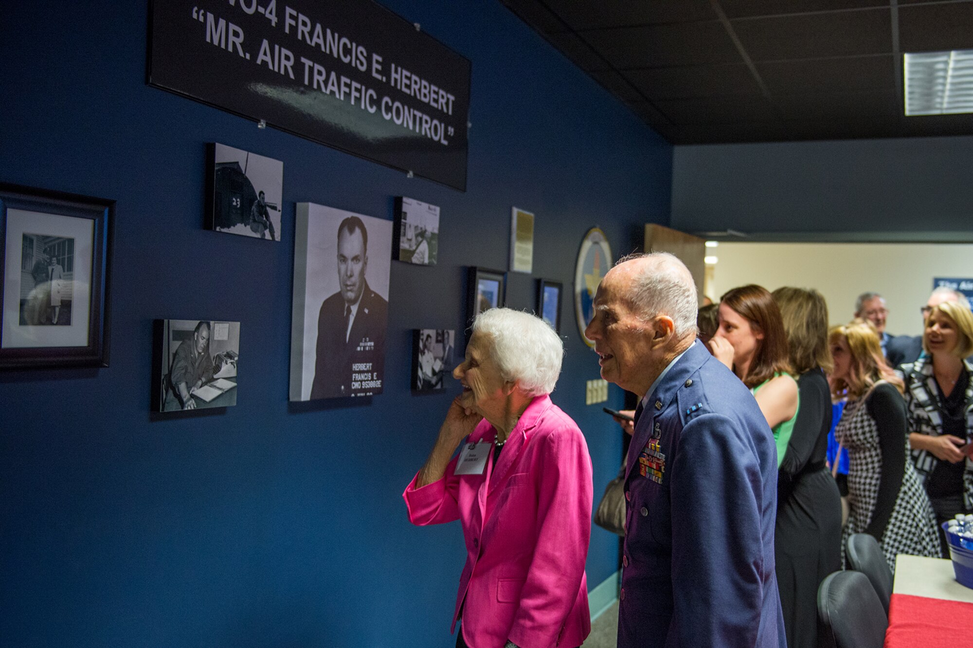 Retired Chief Warrant Officer 4 Francis Herbert, and his wife, Helen, view memorabilia in the tower lab room at Cody Hall April 26, 2016, Keesler Air Force Base, Miss.  The room was dedicated to him for his 50 years of service in air traffic control when he served in the Army, Army Air Corps, and Air Force from 1942-1972, then as a Keesler civilian instructor for 20 years. (U.S. Air Force photo by Marie Floyd)
