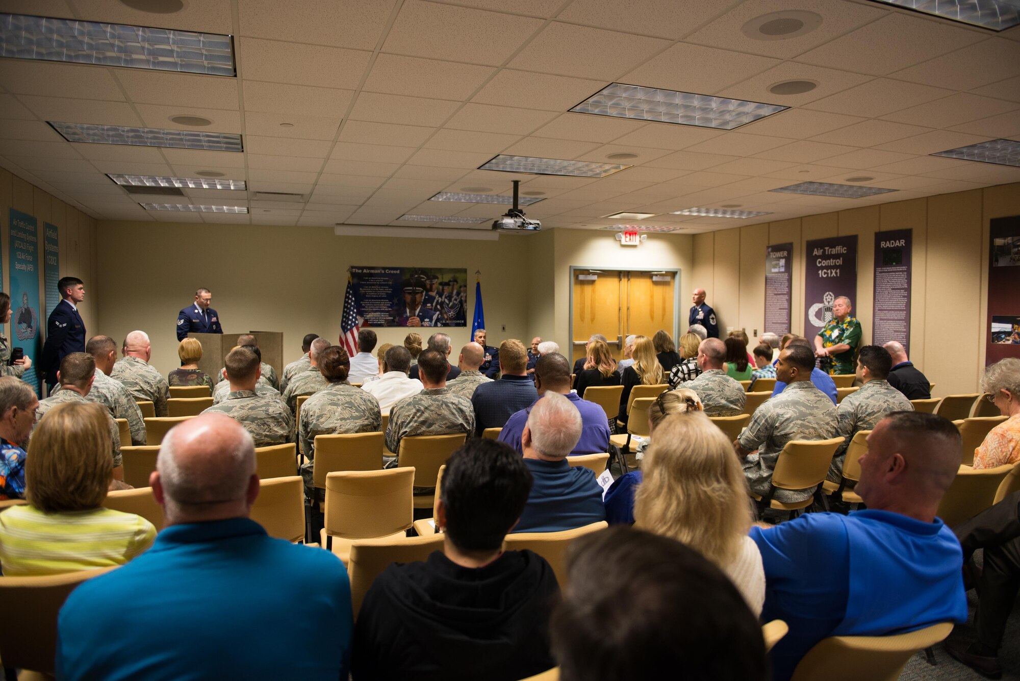 Keesler personnel attend a room dedication ceremony for Retired Chief Warrant Officer 4 Francis Herbert in Cody Hall April 26, 2016, Keesler Air Force Base, Miss. The tower lab room in Cody Hall was dedicated to him for his 50 years of service in air traffic control when he served from 1942-1972, then as a Keesler civilian instructor for 20 years. (U.S. Air Force photo by Marie Floyd)