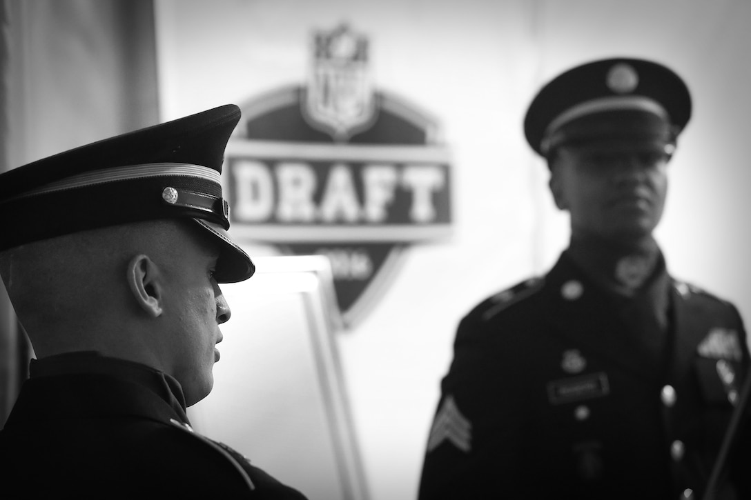 Soldiers from the Army Reserve’s 85th Support Command take a few minutes to themselves before presenting the national colors at the National Football League’s 2016 Draft held in Chicago, April 28, 2016. Service members from each branch of service participated in the opening ceremony of the three-day draft event to include Staff Sgt. Ian Bowling, U.S. Army Field Band, who sang the National Anthem.
(U.S. Army photo by Mr. Anthony L. Taylor/Released)