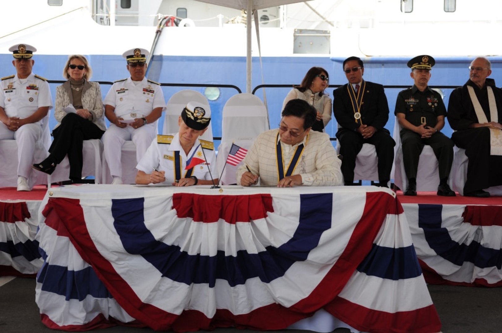 SAN DIEGO (April 27, 2016) - Vice Adm. Nora Tyson, left, commander of U.S. 3rd Fleet, and Leo Herrera-Lim, Philippine Consul General in Los Angeles, sign documents transferring ownership of the research vessel (R/V) Melville to the Philippine Navy during a ceremony at Naval Base, where it was commissioned as BRP Gregorio Velasquez (AGR 702). The ship was transferred under the U.S. Department of Defense's excess defense articles program to help augment the Republic of the Philippines oceanographic research and study capabilities. 