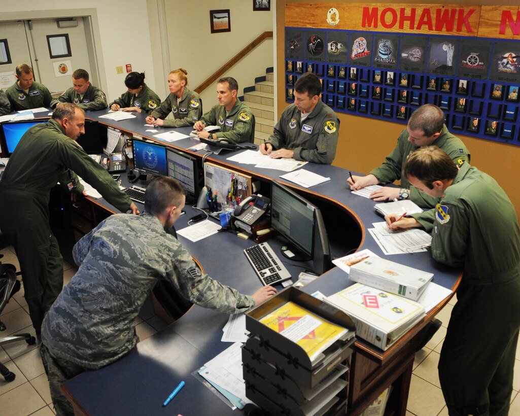 U.S. Air Force Airmen assigned to the 28th Bomb Squadron take notes during a briefing prior to flying April 12, 2016, at Dyess Air Force Base, Texas. Students assigned to the 28th BS who are enrolled in the B-1B Lancer B-course spend three months in the flying phase with training and assistance from instructor pilots. After the flying phase, the students are now able to celebrate their achievements during the new formal graduation. (U.S. Air Force photo by Senior Airman Kedesha Pennant/Released)