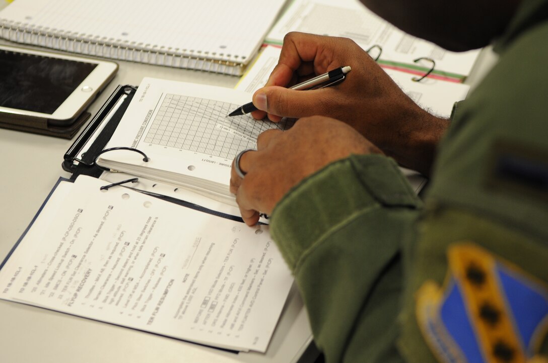 U.S. Air Force 1st Lt. Alfred Agee, 28th Bomb Squadron student pilot, generates aircraft performance calculations of the B-1B Lancer during B-course Class 16-02 April 13, 2016, at Dyess Air Force Base, Texas. These calculations are derived from students learning about flying at a low-level in the B-1. (U.S. Air Force photo by Senior Airman Kedesha Pennant/Released)