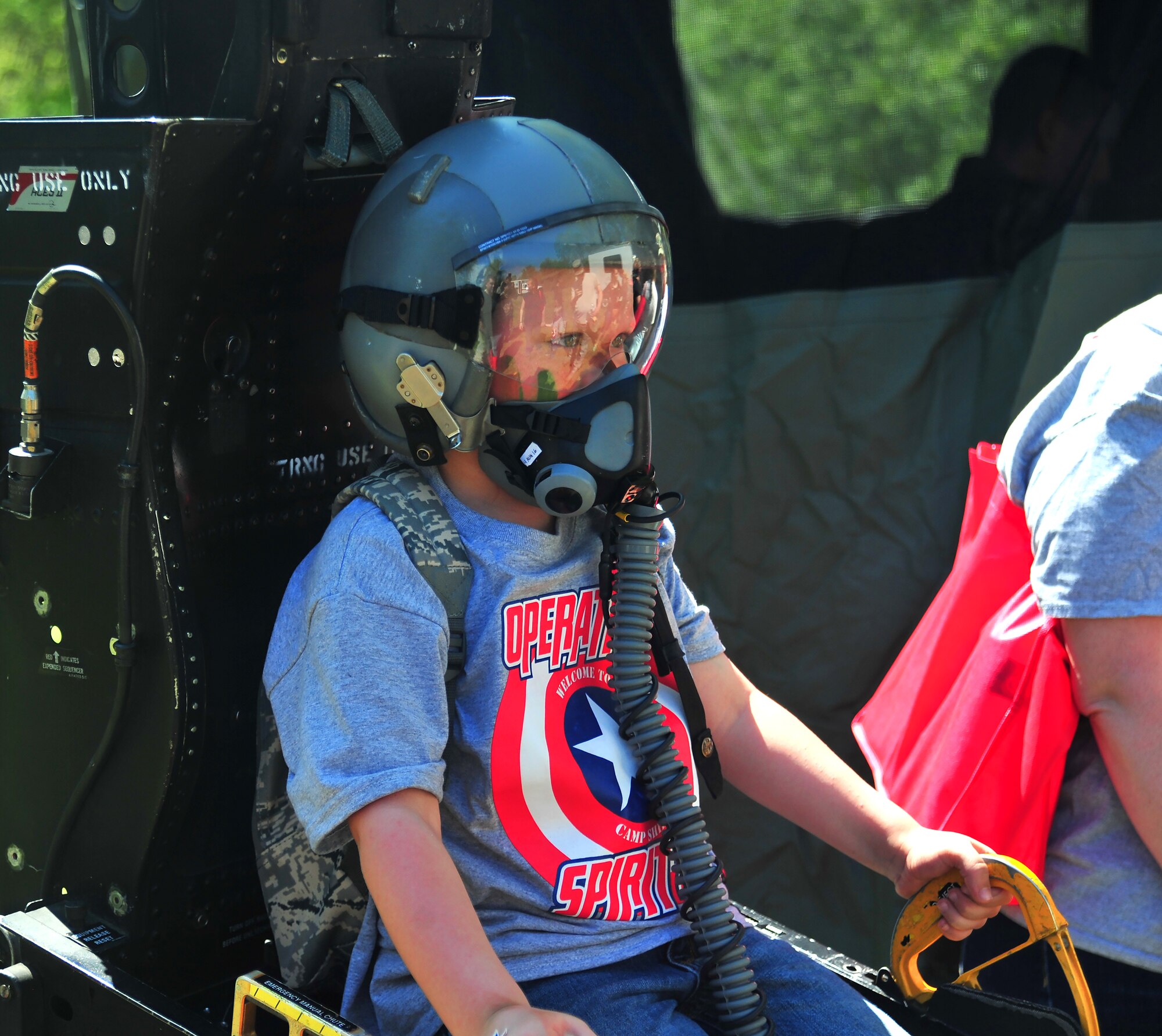 Hunter Lindley, son of Joseph Lindley, the 509th Security Forces Squadron Flight Chief, sits in an ejection-seat display during Operation Spirit at Whiteman Air Force Base, Mo., April 23, 2016. The ejection-seat display was a part of the Survival, Evasion, Resistance and Escape station where Airmen discussed emergency survival tactics with children. (U.S. Air Force photo by Senior Airman Jovan Banks)