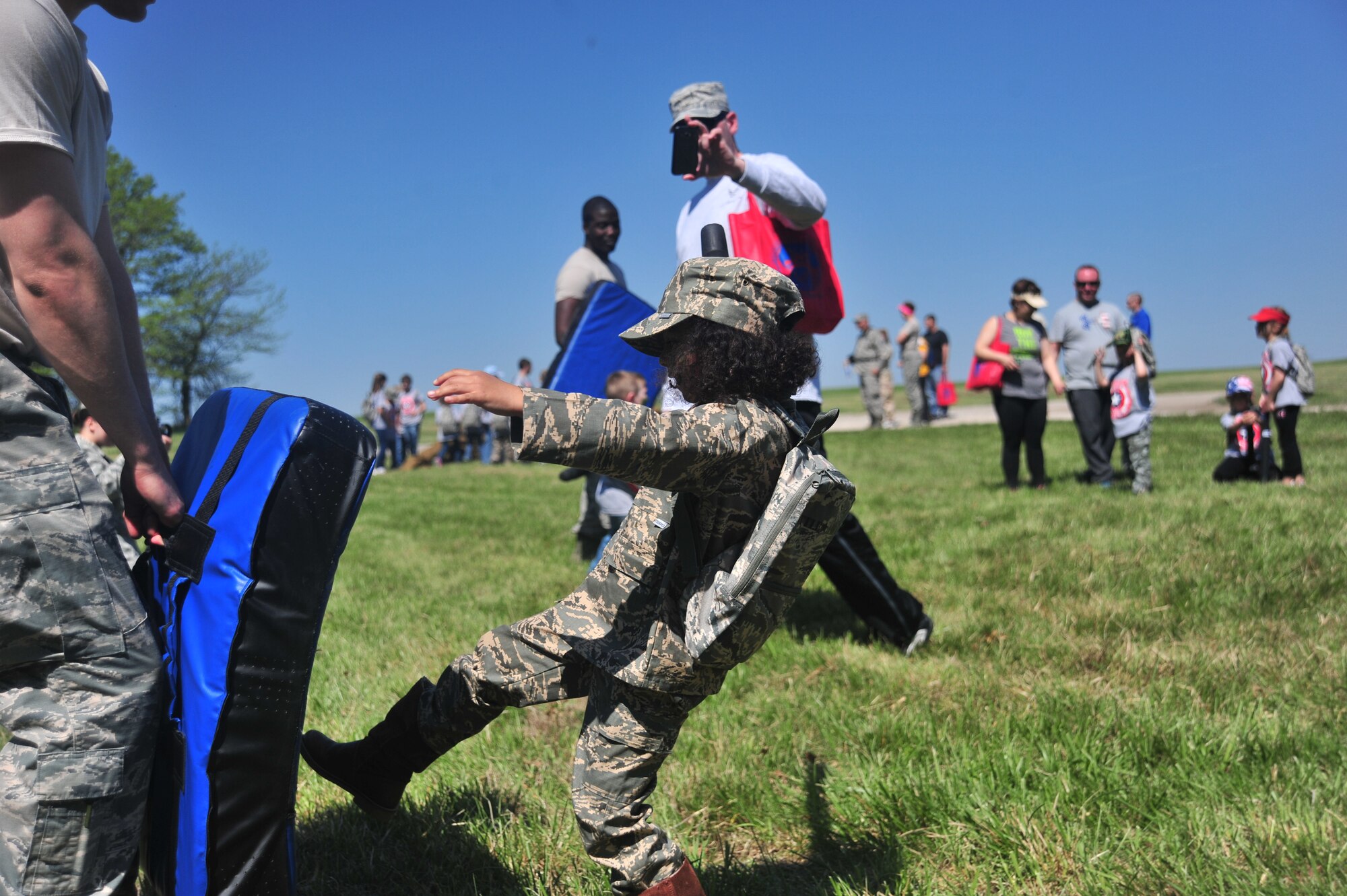 Arissa Hale, daughter of Aris Hale, the base equipment custodian officer assigned to the 509th Communications Squadron, practices her combative techniques at Whiteman Air Force Base, Mo., April 23, 2016. Combatives was one of several stations youth were able to experience during Operation Spirit. (U.S. Air Force photo by Senior Airman Jovan Banks)