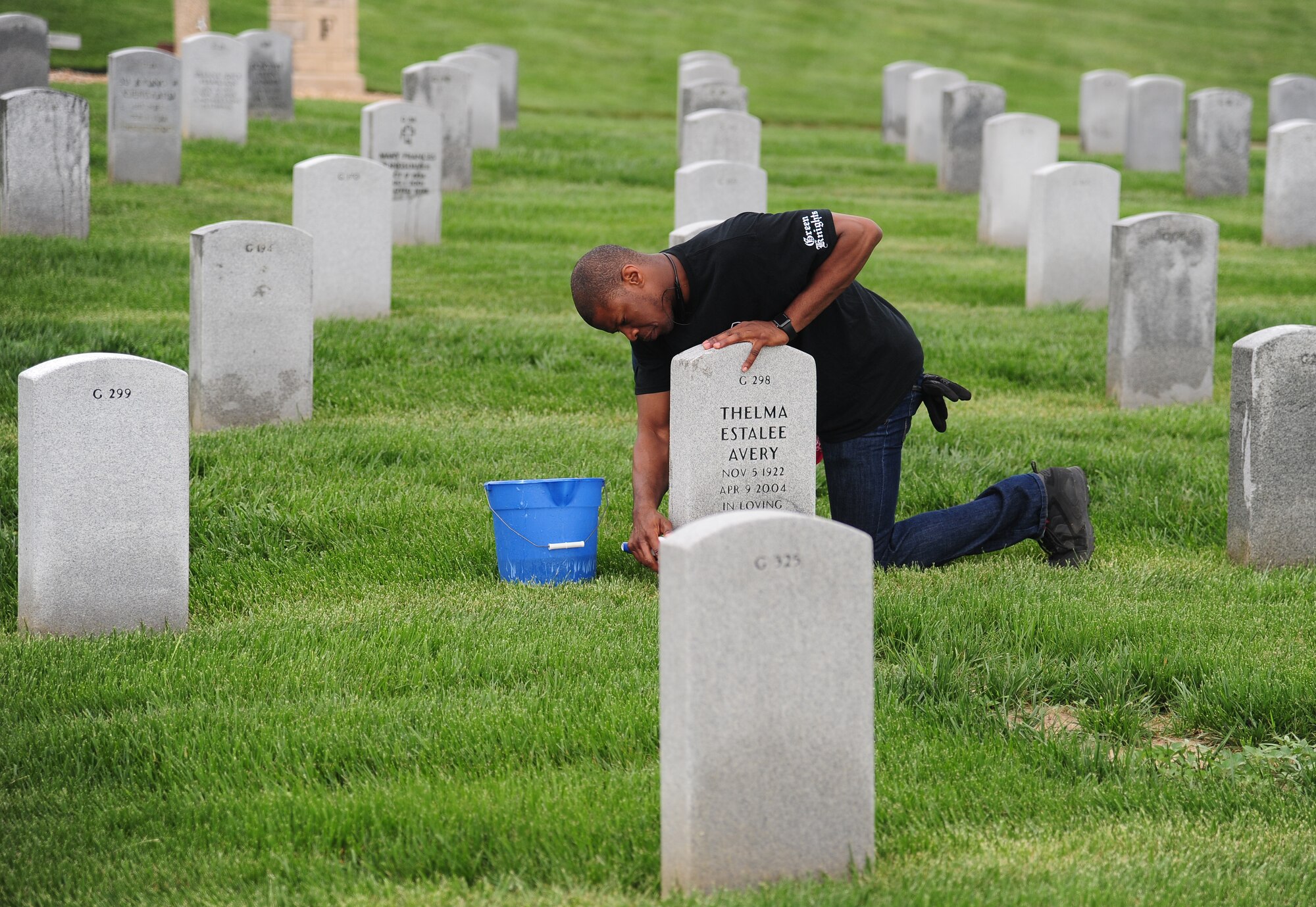 U.S. Air Force Tech. Sgt. Marvin Morris, the 509th Medical Support Squadron NCO in charge of radiology, cleans a headstone at the Missouri Veterans Cemetery in Higginsville, Mo., April 25, 2016. As part of Motorcycle Safety Day, volunteers joined together in a mentorship ride to the cemetery to help clean the grounds. (U.S. Air Force photo by Senior Airman Joel Pfiester)