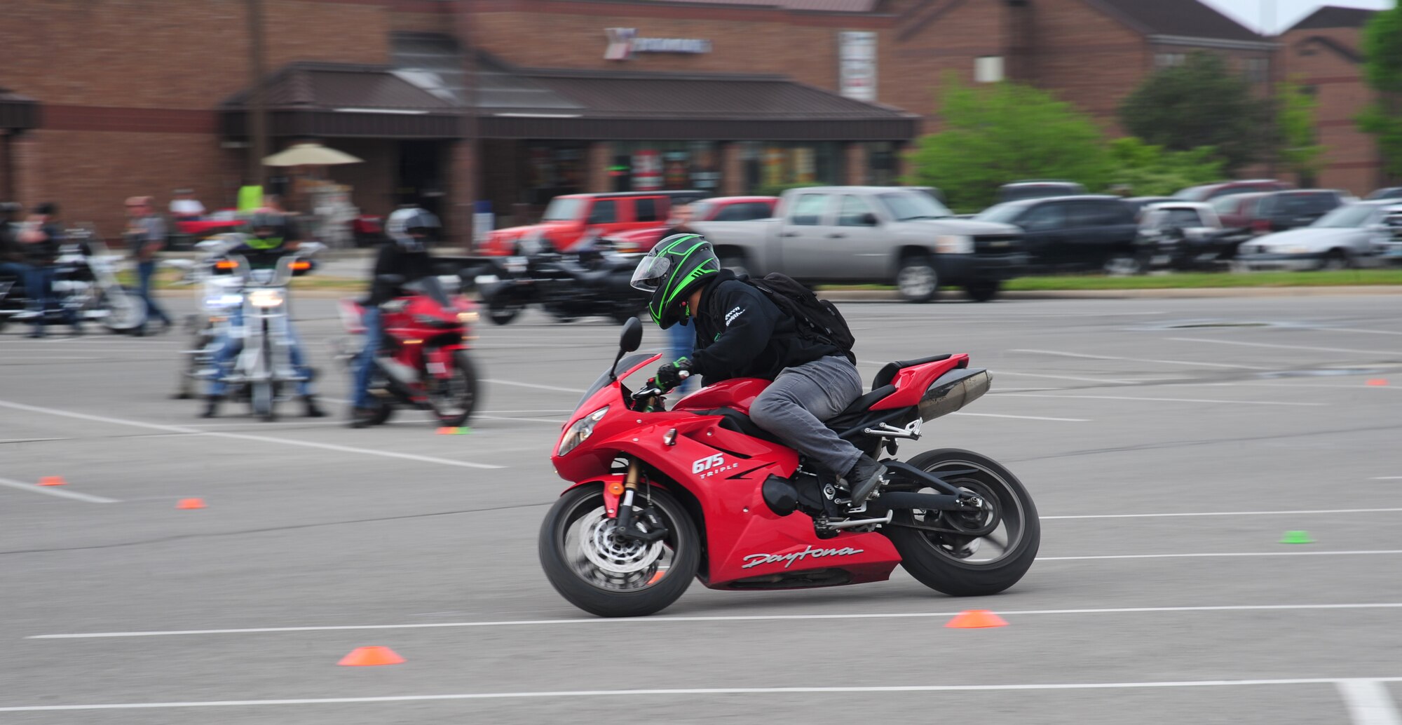 U.S. Air Force Staff Sgt. Krystofer Benson, a 394th Combat Training Squadron client systems technician, rides his bike on the safety course during Motorcycle Safety Day at Whiteman Air Force Base, Mo., April 25, 2016. Motorcycle Safety Day, which consisted of a safety briefing, a safety course, vendor stations and a mentorship ride, was open to everyone from seasoned veterans to first-time riders. (U.S. Air Force photo by Senior Airman Joel Pfiester)