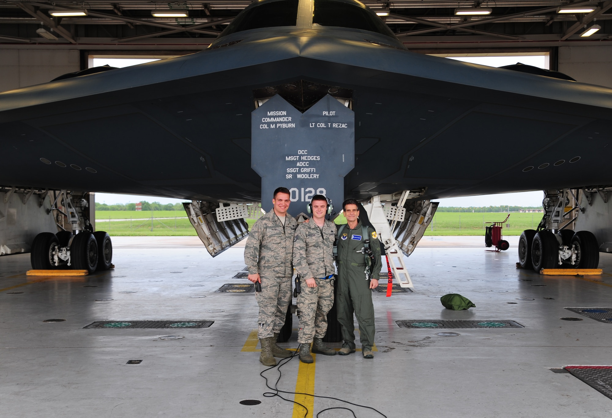 U.S. Air Force 2nd Lt. Benjamin Petry, a 509th Maintenance Squadron (MXS) aircrew ground equipment technician, left, and Staff Sgt. Stephan Kuipers, a 509th MXS crew chief, center, and Dean Kamen, the FIRST Robotics founder, pose for a group photo at Whiteman Air Force Base, Mo., April 26, 2016. Kamen met Airmen and FIRST Robotics alumni during his visit and received an incentive flight in a B-2 Spirit. The U.S. Air Force and FIRST Robotics share an interest in developing youth into future leaders through exposure to education in science, technology, engineering and mathematics. (U.S. Air Force photo by Airman 1st Class Keenan Berry)