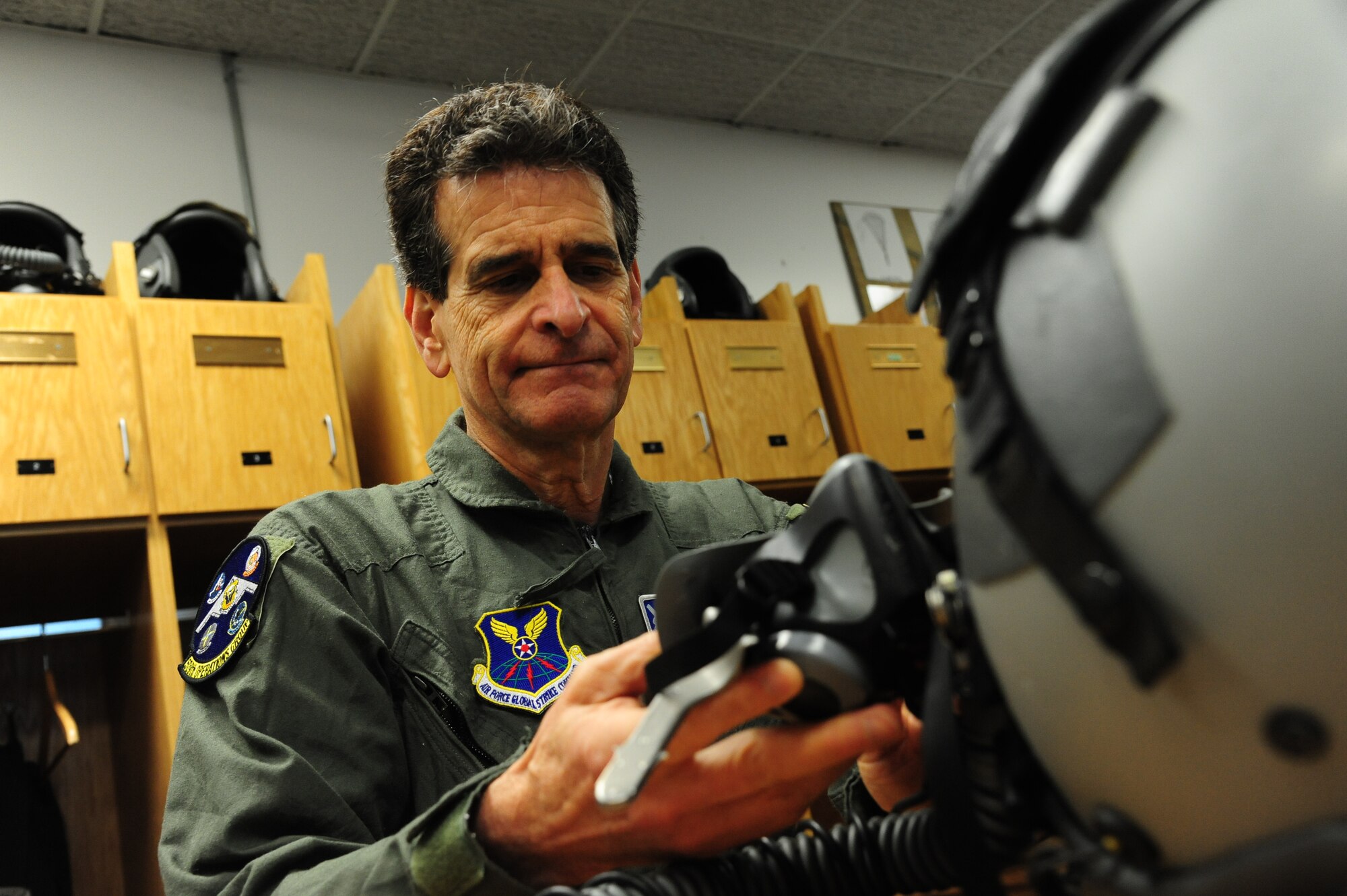 Dean Kamen, the FIRST Robotics founder, examines an MBU-20/P oxygen mask and an HGU-55/P flyer’s helmet at Whiteman Air Force Base, Mo., April 26, 2016. Kamen met Airmen and FIRST Robotics alumni during his visit and received an incentive flight in a B-2 Spirit. The U.S. Air Force and FIRST Robotics share an interest in developing youth into future leaders through exposure to education in science, technology, engineering and mathematics. (U.S. Air Force photo by Airman 1st Class Keenan Berry)