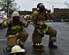 Staff Sgt. Clinton Oliver, 11th Civil Engineer Squadron crew chief, left, and Airman 1st Class Alvaro Munarriz, 11th CES firefighter, put on their gear during a Chemical, Biological, Radiological, Nuclear and Explosives training exercise at Joint Base Andrews, Md., April 28, 2016. The scenario simulated a disgruntled Airman that released ammonia on base to cause mass casualties in the contamination area. (U.S. Air Force photo by Senior Airman Dylan Nuckolls/Released)