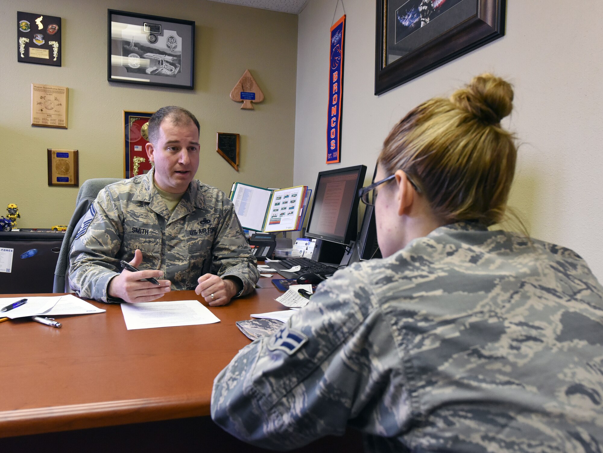 Senior Master Sgt. Cameron Smith, 341st Force Support Squadron career assistance advisor, briefs an Airman April 28, 2016, at Malmstrom Air Force Base, Mont. Smith assists Airmen with career advice by providing information on the benefits and programs the Air Force has to offer. (U.S. Air Force Base photo/Senior Airman Jaeda Tookes)
