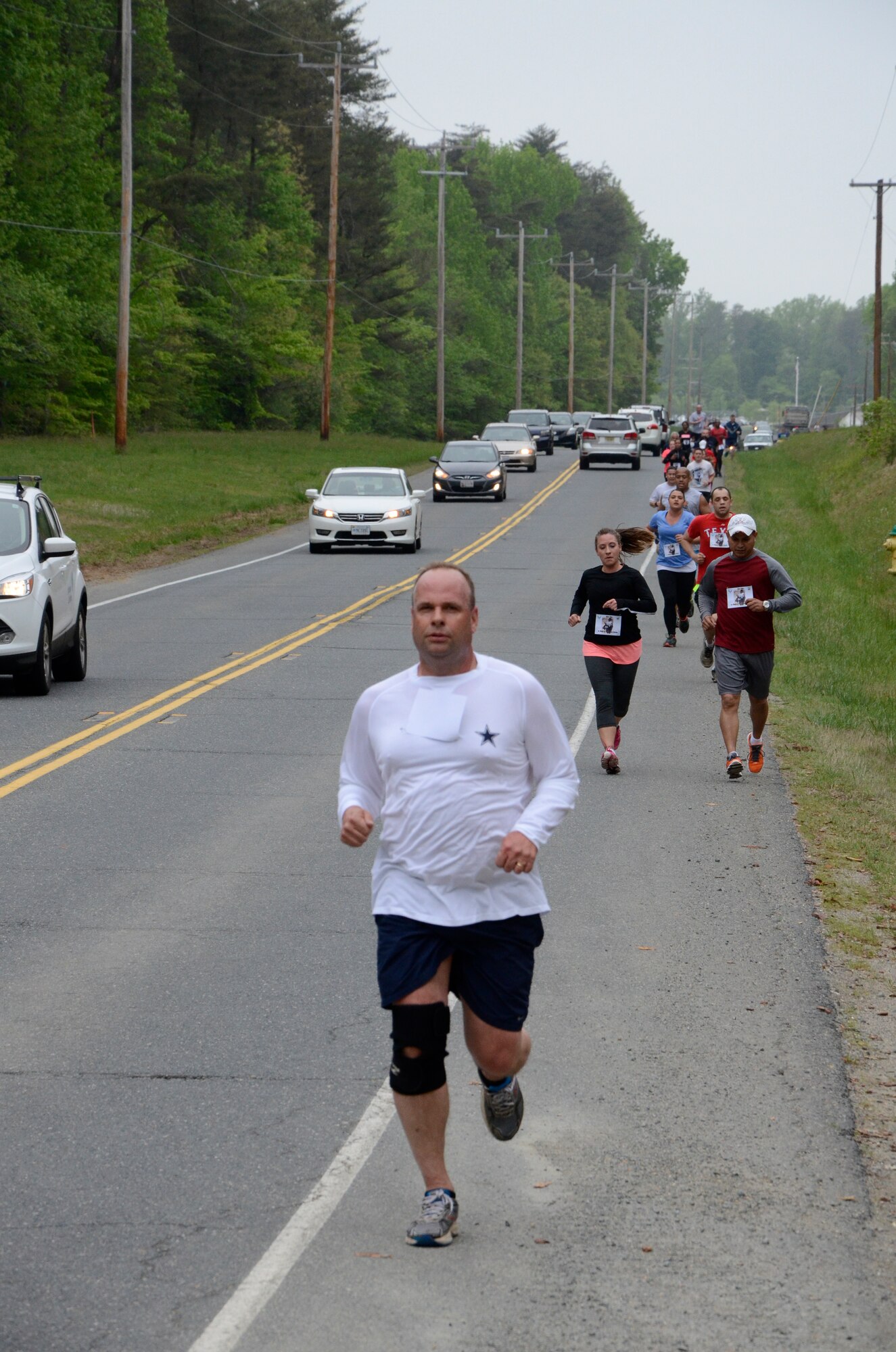 Brig. Gen. Keith M. Givens, Air Force Office of Special Investigations Commander,  leads a group of runners on the return leg of the 3rd Annual Hero Run April 27 at Marine Corps Base, Quantico, Va. The 2.7 mile event honors the memory of OSI member Master Sgt. Tara Brown who was killed, along with seven other courageous Airmen, by a gunman at Kabul International Airport April 27, 2011. (U.S. Air Force photo/Wayne Amann)         