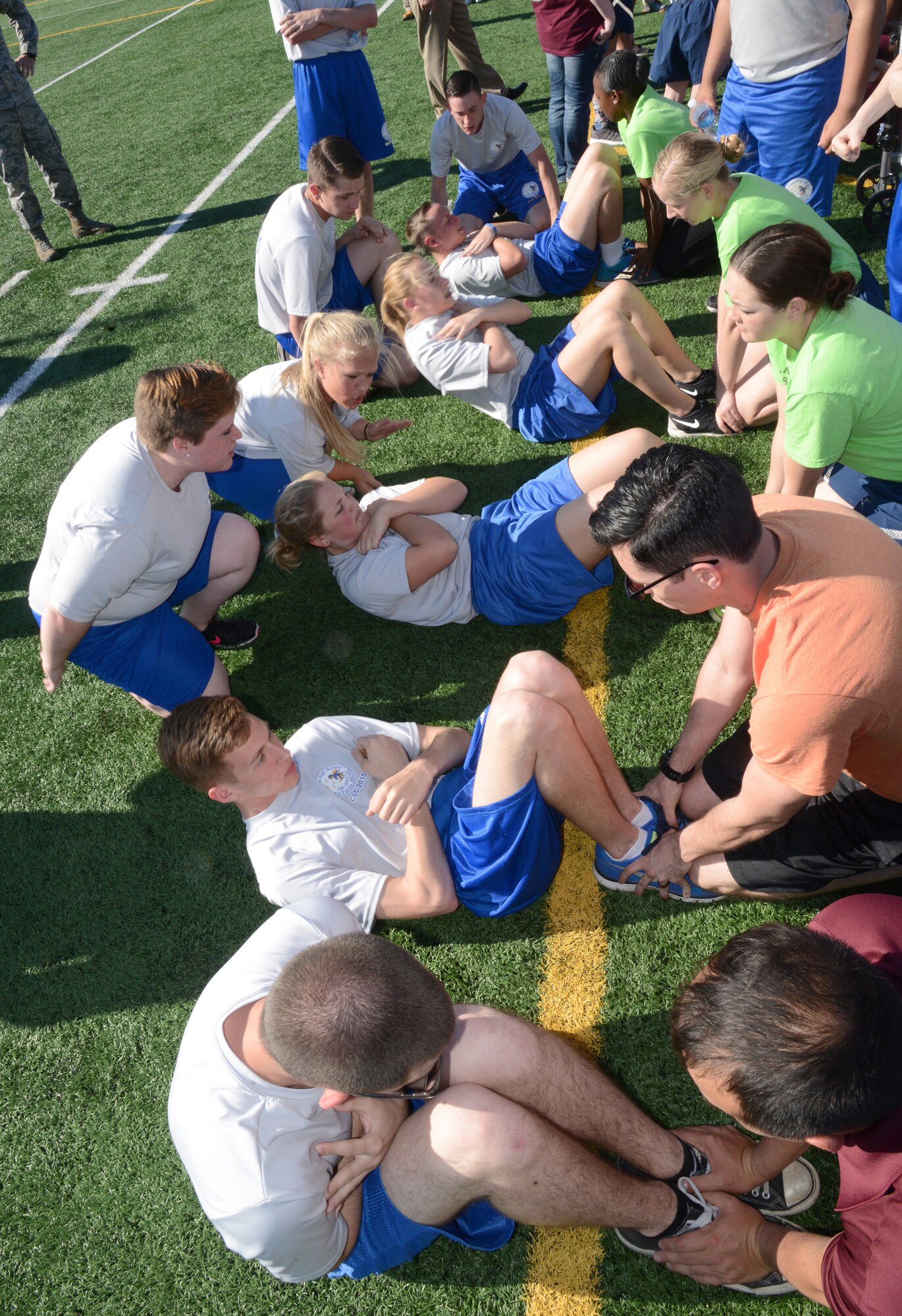 Choctaw Air Force Junior Reserve Officer Training Corps members participate in the one-minute sit-ups competition during the 349th Recruiting Squadron’s community outreach event. (Air Force photo by Kelly White/Released)