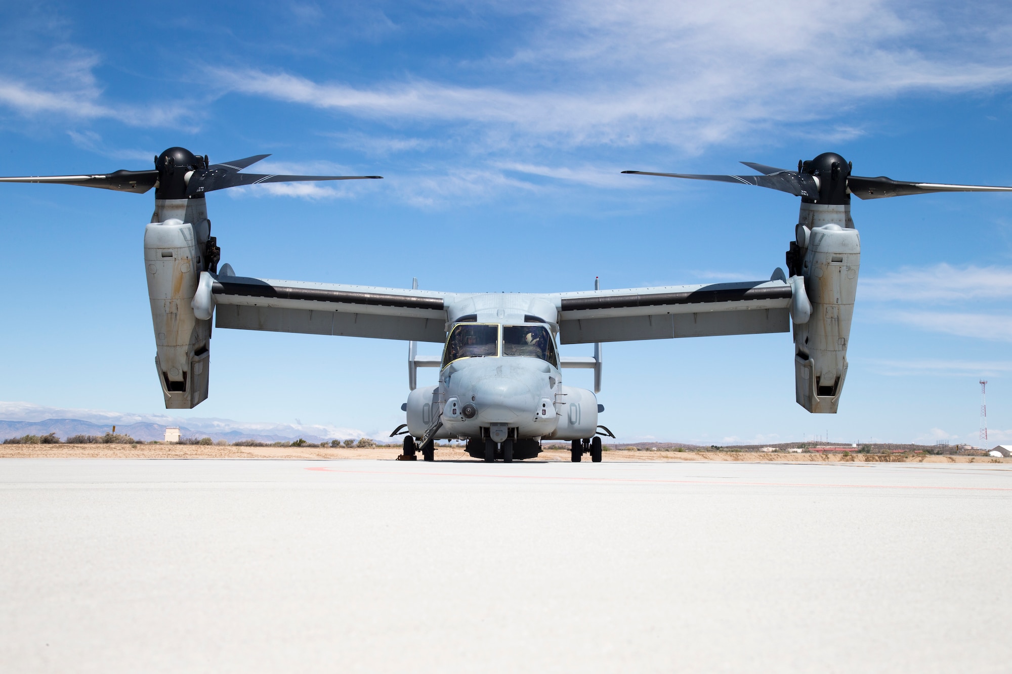 The MV-22B Osprey is a tiltrotor vertical and/or short take-off and landing aircraft that serves as the medium-lift assault support aircraft for the Marines. The Osprey can operate as a helicopter or a turboprop aircraft. It can transport troops, equipment and supplies from ships and land bases for combat assault and support. Edwards AFB hasn’t seen an Osprey in the skies regularly since 2007. That’s the year the 418th Flight Test Squadron said goodbye to the CV-22 Integrated Test Team after completing developmental test of the aircraft. (U.S. Air Force photo by Chris Higgins) 
