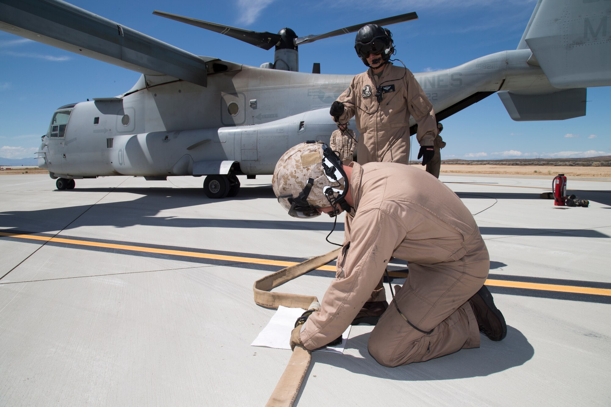 Marines from Marine Operational Test & Evaluation Squadron 22 out of Marine Corps Air Station Yuma in Arizona, connect fuel hoses between a Marine MV-22 and F-35B. The relatively short test validated the equipment and procedures on both the F-35B and MV-22 for ground refueling. (U.S. Air Force photo by Chris Higgins) 
