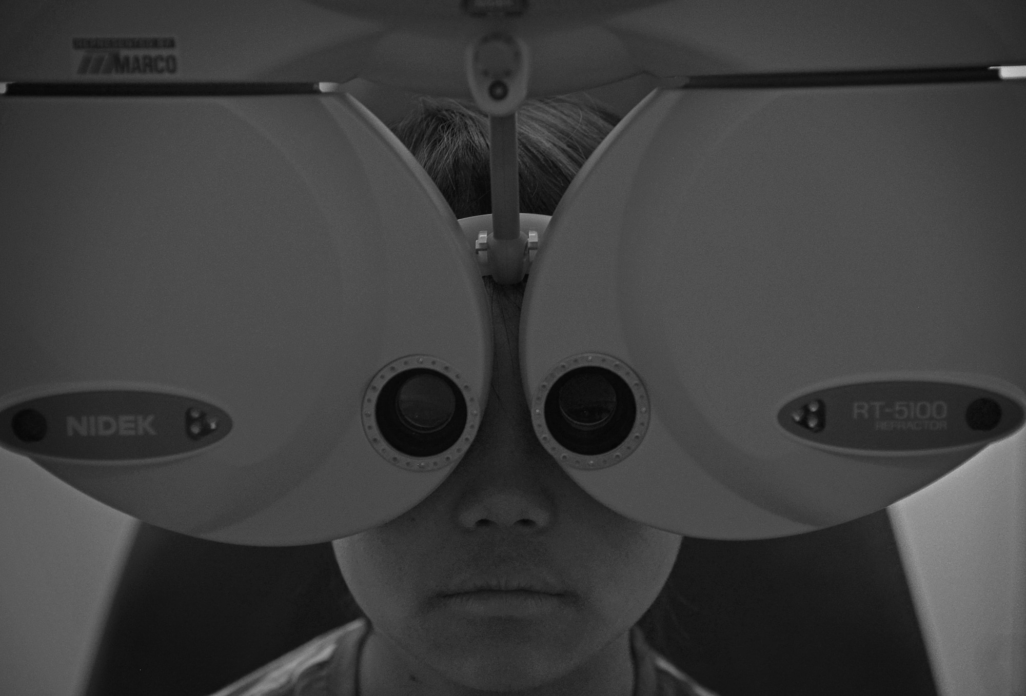 Seina Karr, 12, daughter of Tech Sgt. Ryan Karr, 374th Civil Engineer Squadron, looks through a Nidek RT-5100 Refractor to be checked for a prescription for glasses at Yokota Air Base, Japan, April 26, 2016. Yokota members are able to receive glasses prescription update, refractive eye surgery and gas mask inserts from the clinic. (U.S. Air Force photo by Senior Airman David Owsianka/Released)