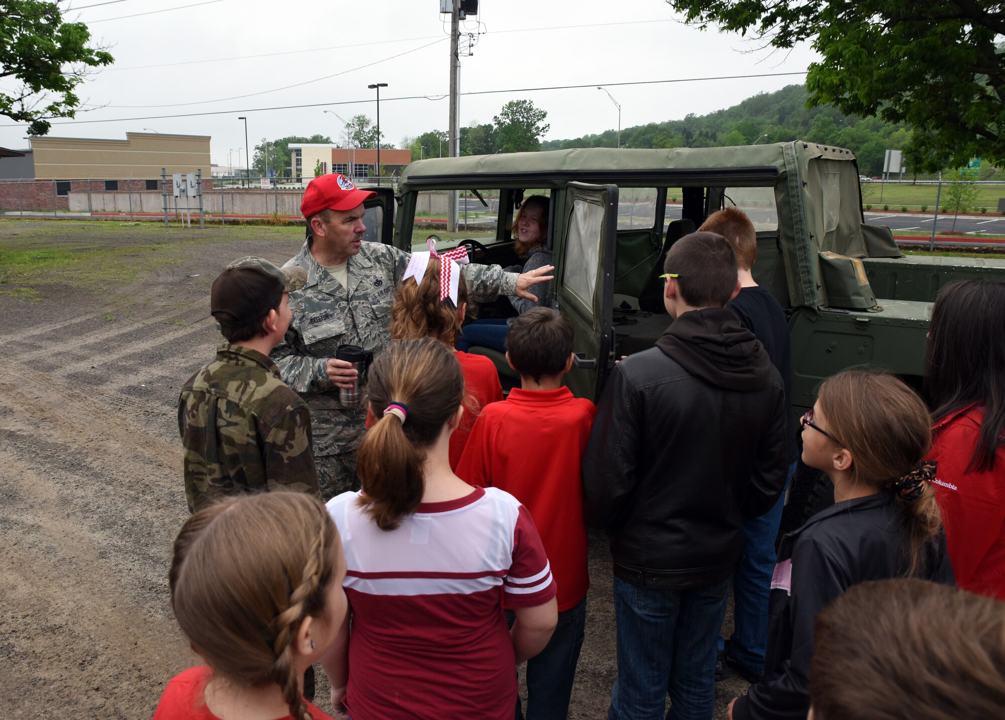 Chief Master Sgt. Gary Skelton, rapid engineer deployable heavy operational repair squadron engineer (REDHORSE) training center chief, shows students from Mansfield Elementary School a Humvee during their visit to the 188th Wing April 20, 2016, at Ebbing Air National Guard Base, Fort Smith, Ark. The students were shown careers in civil engineering, remotely piloted aircraft and security forces. (U.S. Air National Guard photo by Senior Airman Cody Martin/Released)