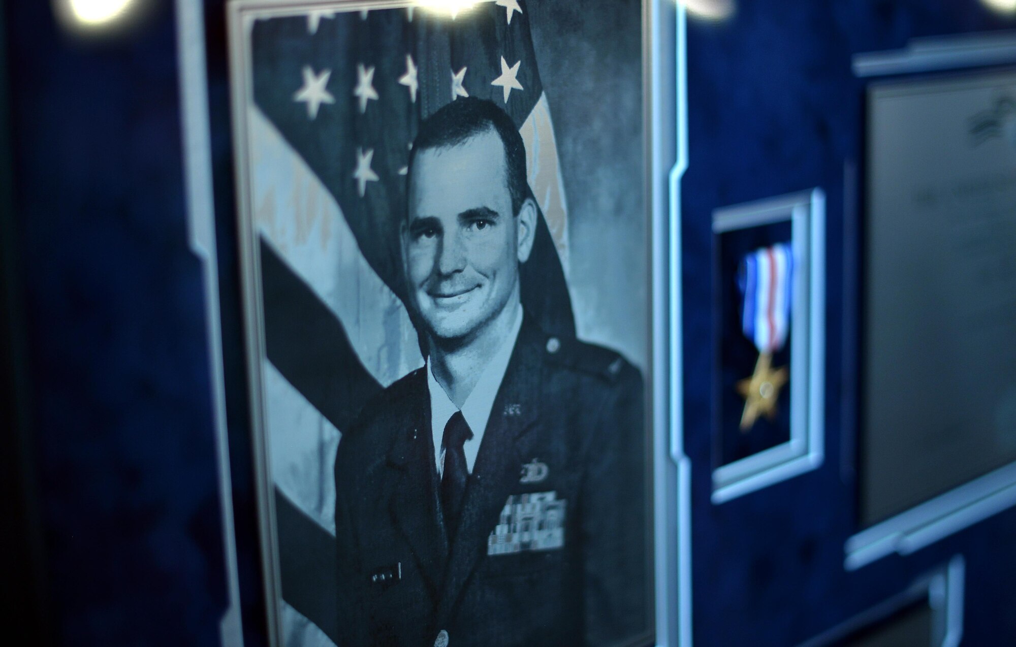 Pictured is a plaque of fallen weather warrior U.S. Air Force Capt. Nathan Nylander. They 557th Weather Wing hosted a remembrance ceremony for him April 27, 2016 in their auditorium. (U.S. Air Force photo by Josh Plueger)