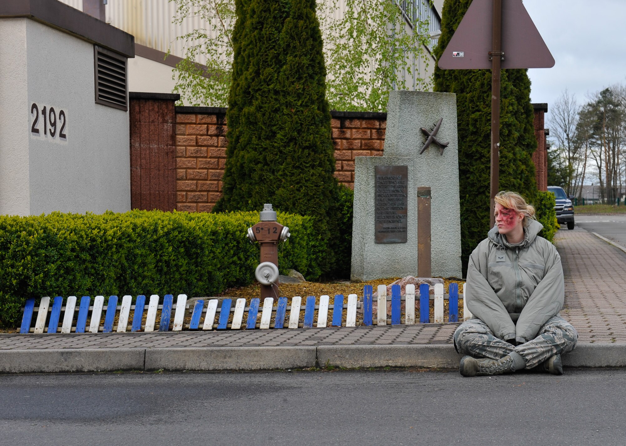 Senior Airman Erica Hyatt, 86th Aeromedical Evacuation Squadron aeromedical evacuation technician and simulated casualty, waits for first responders during the Wing Thunder inspection April 26, 2016, at Ramstein Air Base, Germany. Hyatt was selected as one of eight simulated casualties during the simulated base attack that helped inspectors evaluate the operational readiness of Team Ramstein. (U.S. Air Force photo/Staff Sgt. Leslie Keopka)