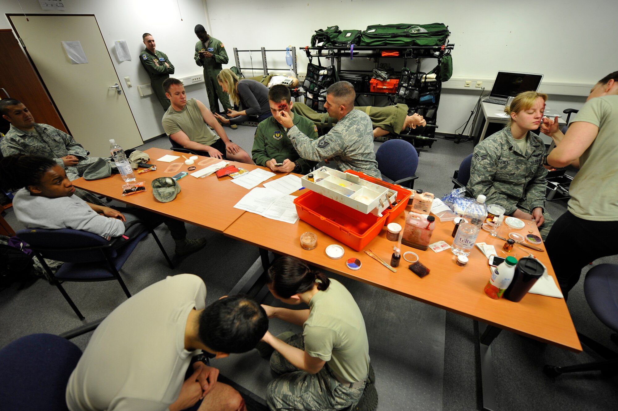 A team from the 86th Aeromedical Evacuation Squadron prepares Airmen to look like simulated casualties during the Wing Thunder inspection April 26, 2016, at Ramstein Air Base, Germany. The simulated casualties were given injuries such as broken bones, shrapnel in skin and pavement burns to participate in the simulated missile attack. (U.S. Air Force photo/Staff Sgt. Leslie Keopka)