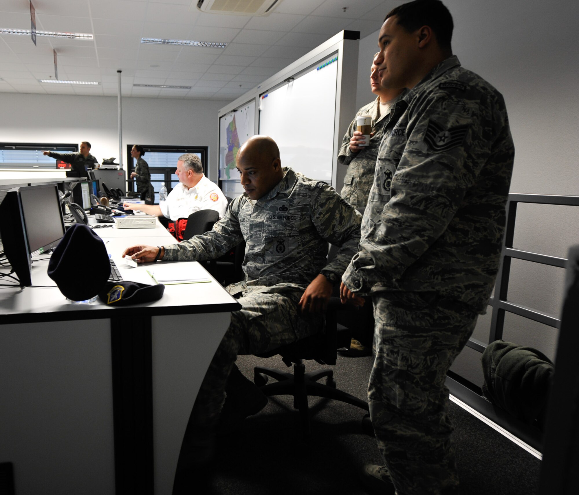Personnel from the 86th Security Forces Squadron review a checklist in the emergency operations center during the Wing Thunder inspection  April 25, 2016 at Ramstein Air Base, Germany. The checklists are designed to ensure personnel go through all the proper procedures during exercises and real-world scenarios. (U.S. Air Force photo/Staff Sgt. Leslie Keopka)
