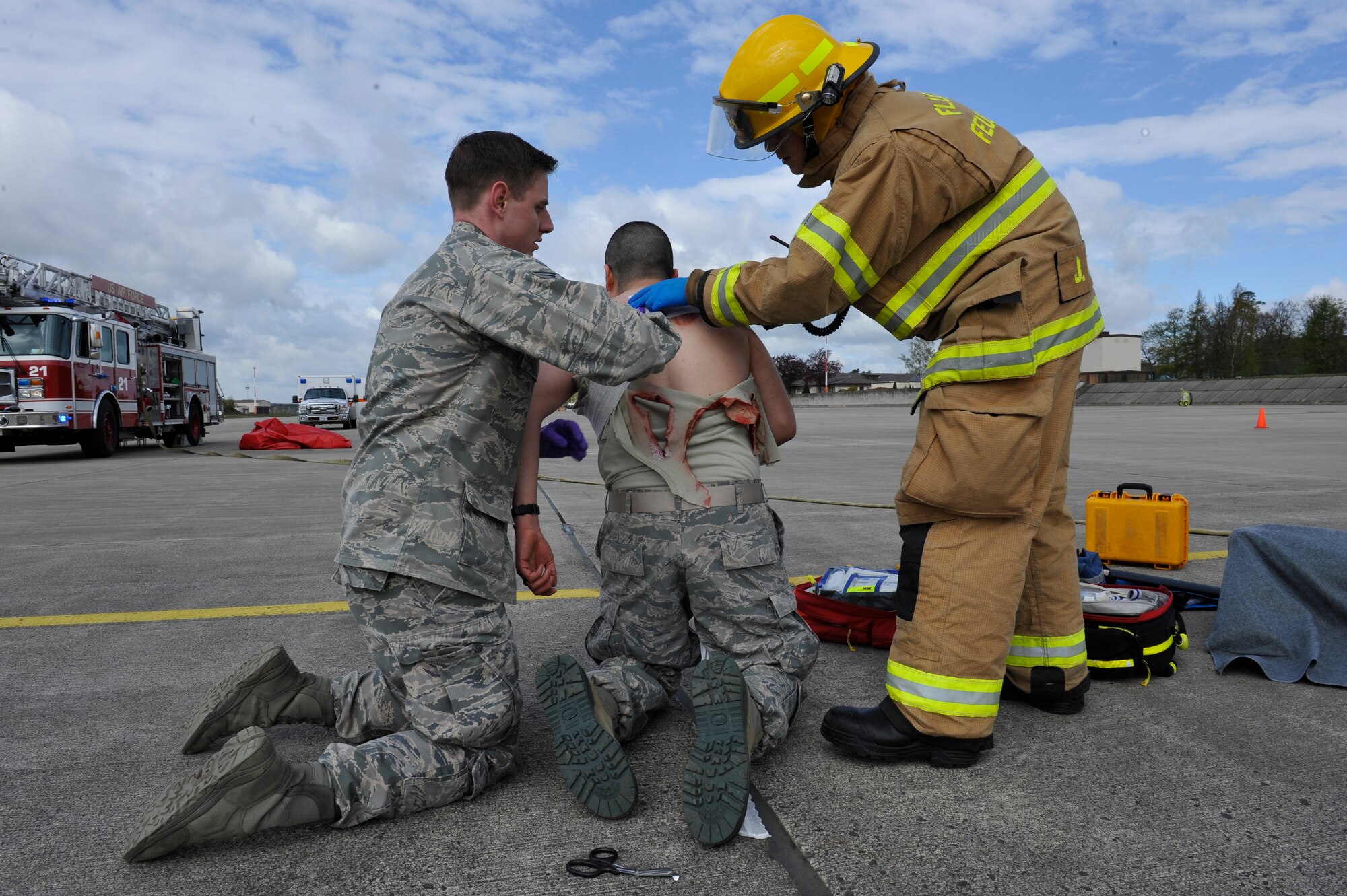 First responders assist a simulated- missile attack casualty during the Wing Thunder inspection April 26, 2016, at Ramstein Air Base, Germany. The first responders arrive on scene first to ensure the scene is safe and all victims are helped in a timely matter. (U.S. Air Force photo/Staff Sgt. Leslie Keopka)