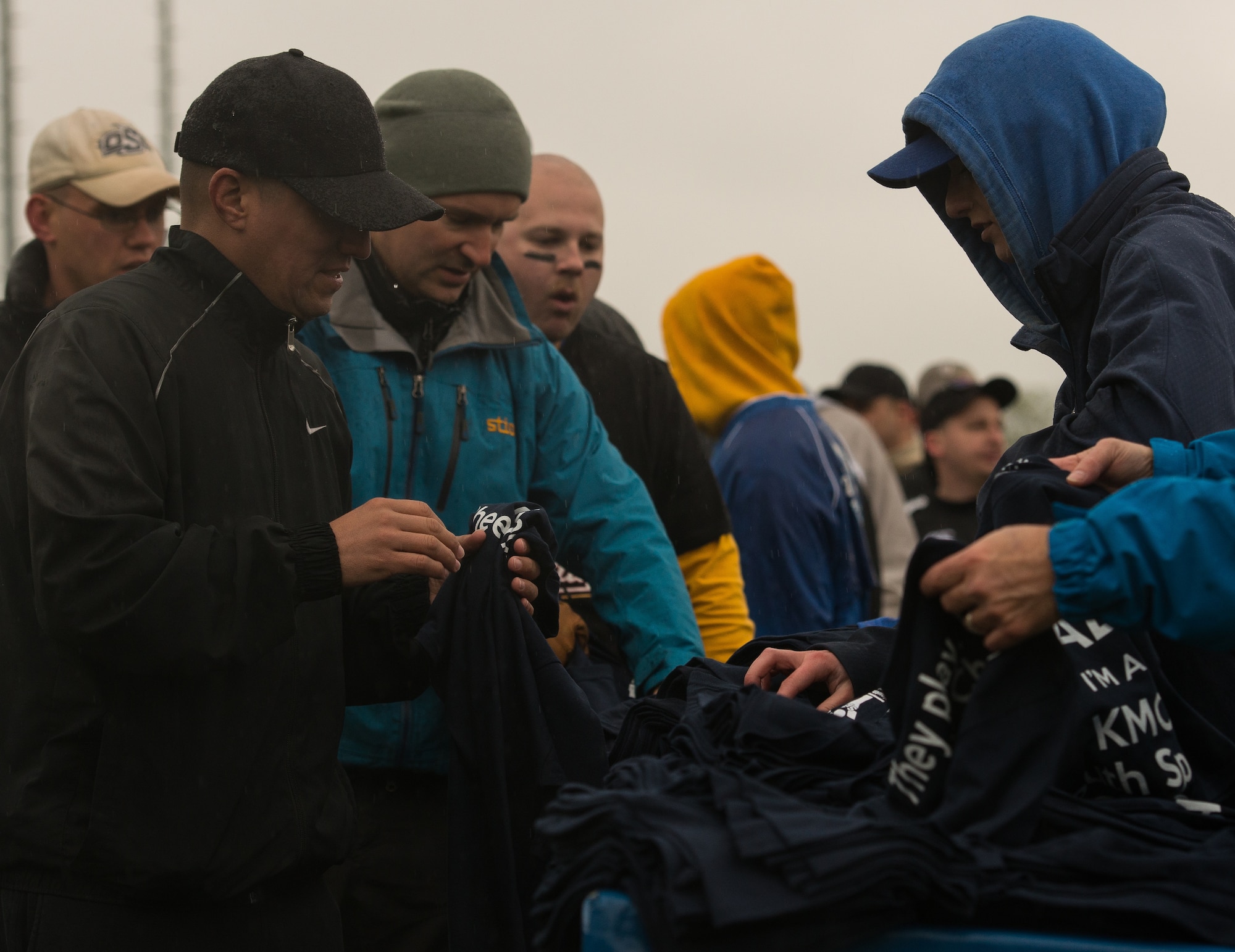 Shirts are handed out to baseball coaches during the ceremonial first pitch event April 23, 2016, at Ramstein Air Base, Germany. The event is a longstanding ritual of American baseball in which a guest of honor throws the first pitch to launch the new season.  (U.S. Air force photo/Airman 1st Class Lane T. Plummer)