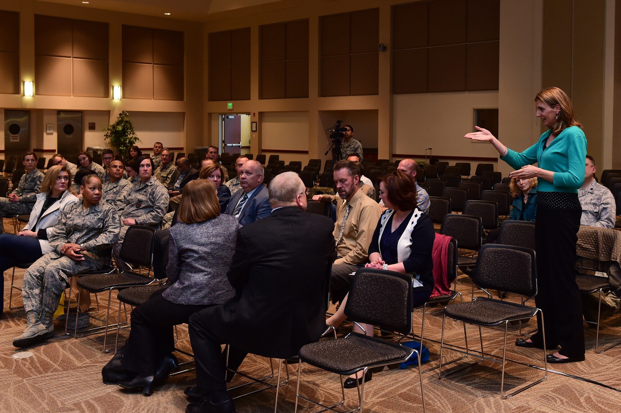 Christina Grooms, 460th Space Wing community support coordinator, answer a question about community engagement events during a town hall meeting April 28, 2016, at the Leadership Development Center on Buckley Air Force Base, Colo. During the town hall meeting, leaders addressed questions and concerns community members had and highlighted improvements made to base. (U.S. Air Force photo by Airman 1st Class Luke W. Nowakowski/Released)