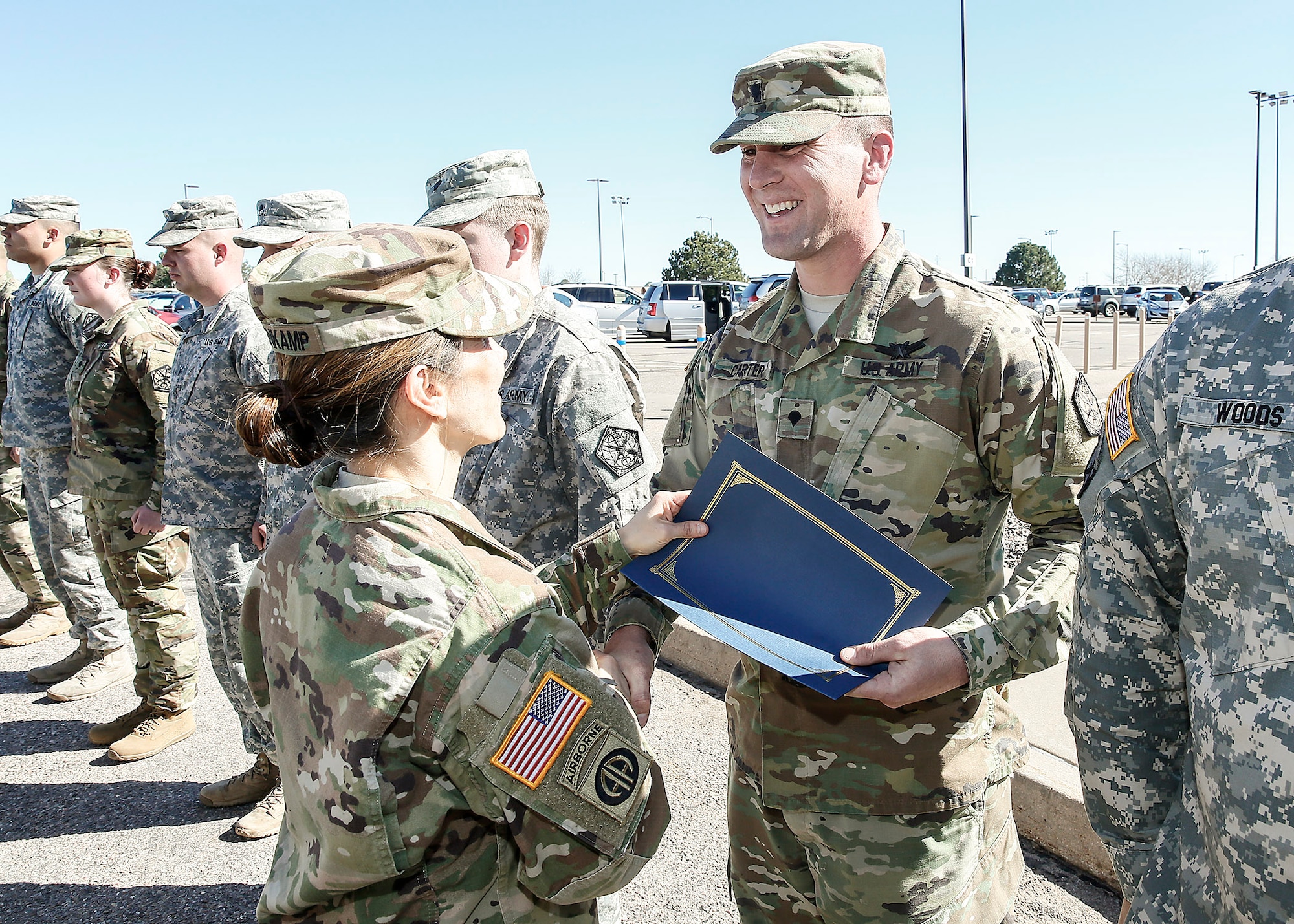 U.S. Army Spc. Brian Carter, 743d Military Intelligence Battalion Alpha company, receives a certificate from Col. Michele Bredenkamp, 704th Military Intelligence Battalion brigade commander, during a Space Badge presentation ceremony March 10, 2016, at Buckley Air Force Base, Colo. The badge was formerly called the Air Force Space Badge, but Air Force was dropped from the name because the Army and Air Force personnel are now eligible, calling the badge the Space Badge. (U.S. Army photo by Sgt. Kristopher Dimond/Released)