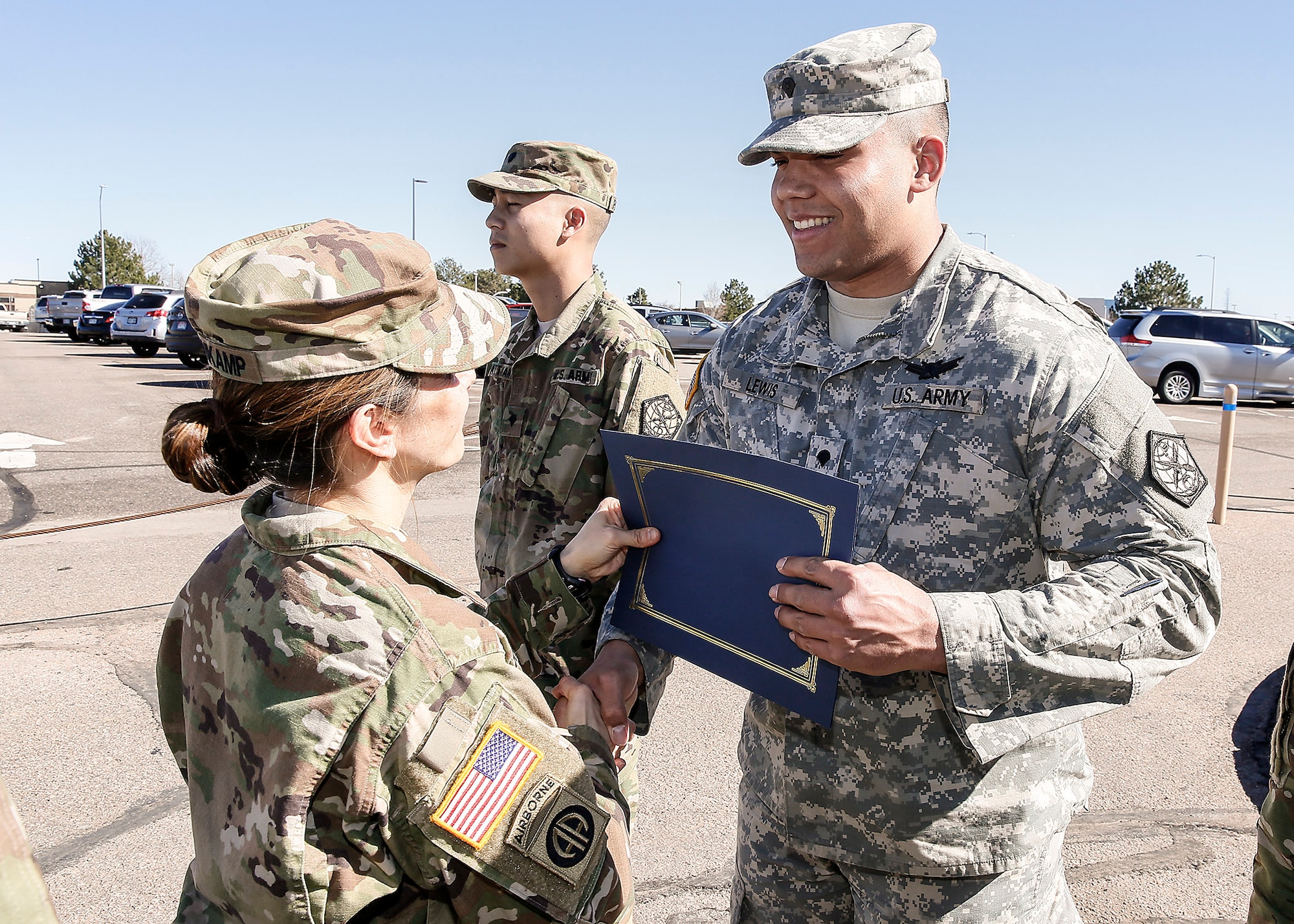 U.S. Army Col. Michele Bredenkamp, 704th Military Intelligence Battalion brigade commander, gives Spc. Kevin Lewis, 743d Military Intelligence Battalion Alpha company, his Space Badge certificate March 10, 2016, at Buckley Air Force Base, Colo. The Space Badge can be awarded to active Army, Army Reserve and National Guard Soldiers who successfully complete appropriate space-related training and attain the required Army space cadre experience. There are three levels of the Space Badge: basic, senior and master. (U.S. Army photo by Sgt. Kristopher Dimond/Released) 