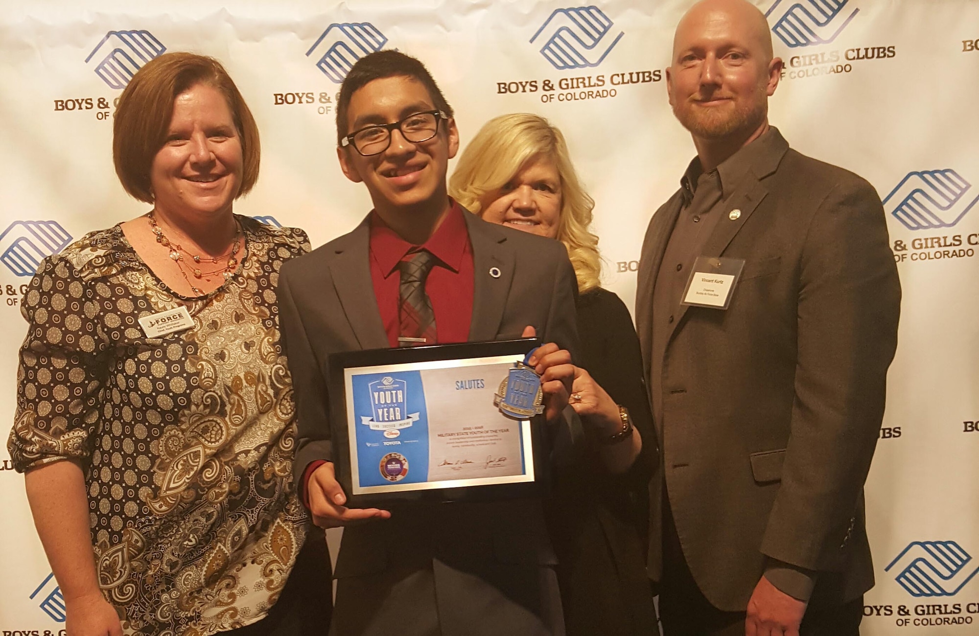 Ernesto Flores, 2016 Colorado Military Youth of the Year, receives a plaque March 22, 2016, during the Colorado Youth of the Year ceremony in Denver, Colo. The Youth of the Year program honors young people on their path to great futures and encourages all young adults to lead, succeed and inspire. (Courtesy Photo)