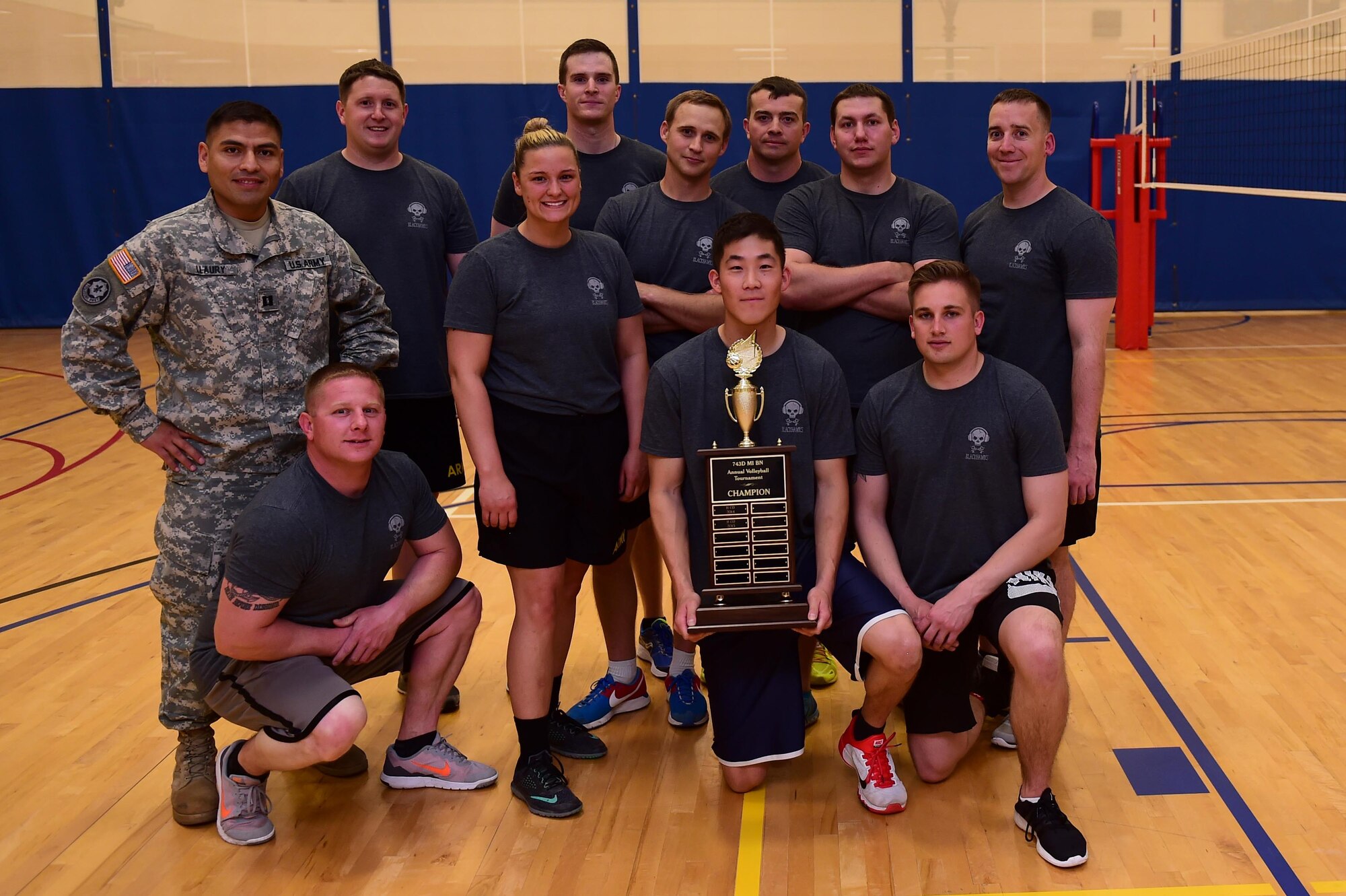 Members of the 743d Military Intelligence Battalion gather together after winning an annual volleyball tournament April 28, 2016, at the Buckley Fitness Center on Buckley Air Force Base, Colo. The tournament, a Commander’s Cup event, provided bragging rights to the winning team and allowed participants the opportunity for inter-battalion competition. (U.S. Air Force photo by Airman 1st Class Gabrielle Spradling/Released)