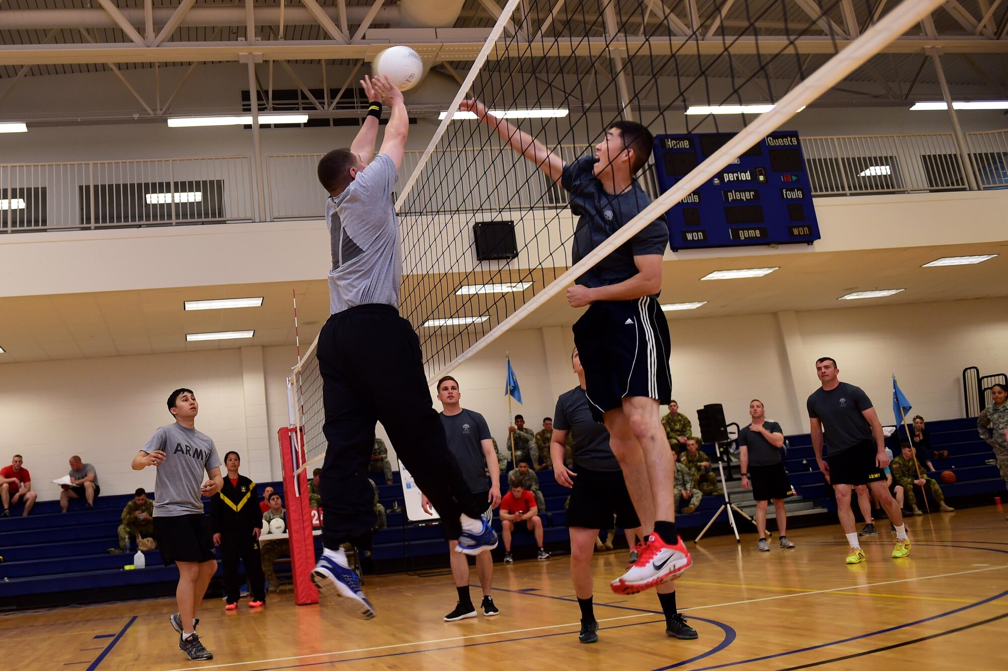 U.S. Army Spc. Howie Kim, 743d Military Intelligence Battalion signals analyst, blocks a spike by U.S. Army Sgt. David Perez, 743d Military Intelligence Battalion S3 training, April 27, 2016, at the Buckley Fitness Center on Buckley Air Force Base, Colo. The tournament consisted of three teams competing for two days with the winning team walking away with a trophy and bragging rights. (U.S. Air Force photo by Airman 1st Class Gabrielle Spradling/Released)