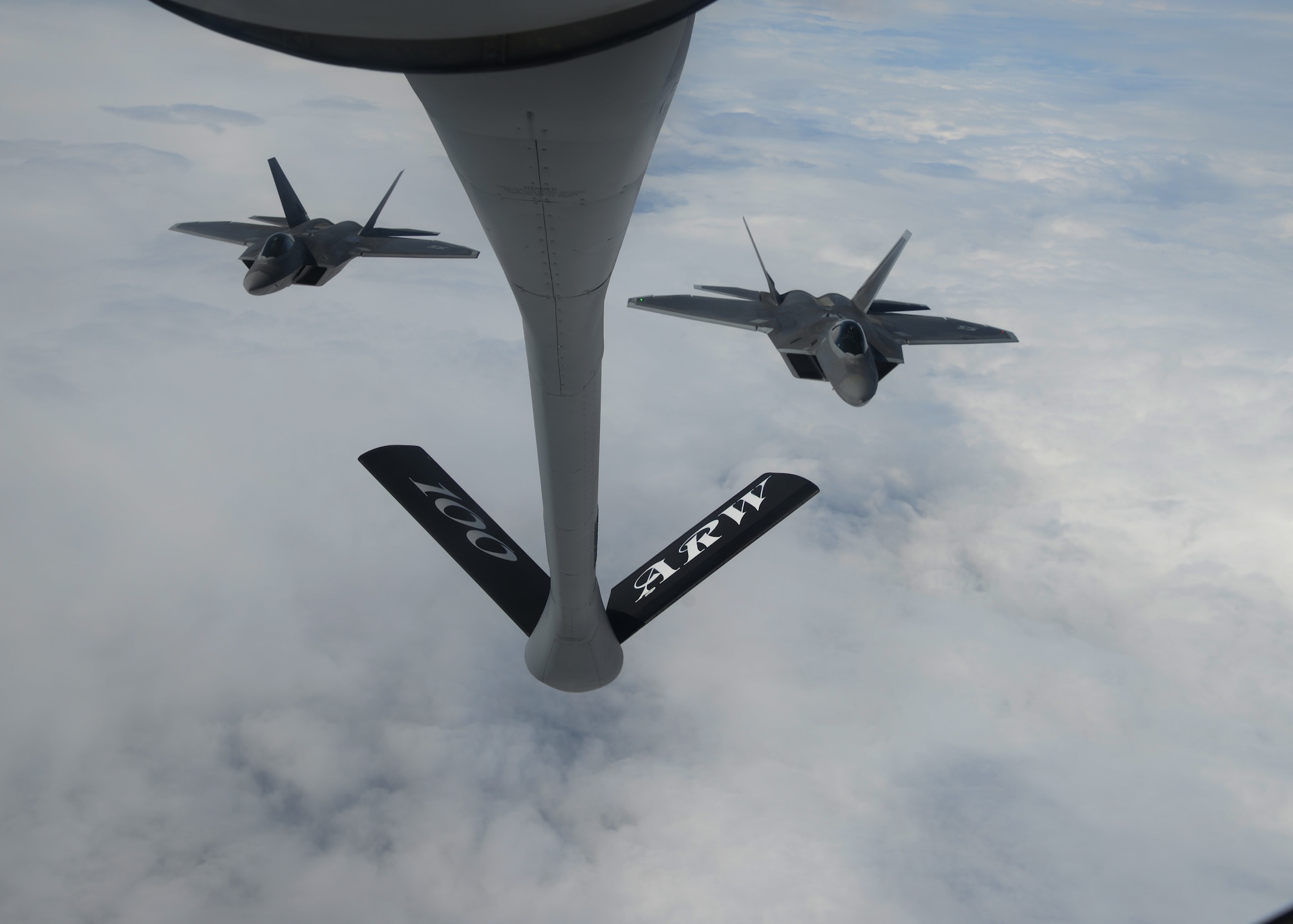 Two U.S. Air Force F-22 Raptors assigned to the 95th Fighter Squadron at Tyndall Air Force Base, Fla., fly in formation behind a 100th Air Refueling Wing KC-135 Stratotanker assigned to RAF Mildenhall, England April 27, 2016, in route to Šiauliai Air Base, Lithuania. The aircraft will conduct air training with other Europe-based aircraft, demonstrating the U.S. commitment to NATO allies and the security of Europe. (U.S. Air Force photo by Staff Sgt. Nathan Tucker/Released)