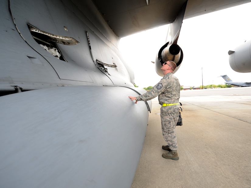Master Sgt. Jered Pieschke, a Unit Effectiveness Inspection crew chief inspector, examines the screws on a C-17 Globemaster III at Joint Base Charleston April 13, 2016. More than 120 inspectors and approximately 60 observers traveled to Joint Base Charleston to help with the Unit Effectiveness Inspection. (U.S. Air Force Photo/Airman Megan Munoz)