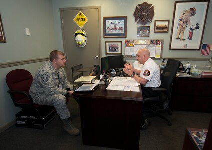 Master Sgt. Mike Kellebrew, a Unit Effectiveness Inspection fire emergency inspector, reviews Joint Base Charleston fire fighters’ training records with Keith Jimmo, the 628th Civil Engineering Squadron assistant chief of health and safety, on April 13, 2016 at the Joint Base Charleston Fire Department. UEIs are performed to bring strengths and weaknesses to the attention of unit leaders to make improvements. (U.S. Air Force Photo/Airman Megan Munoz)