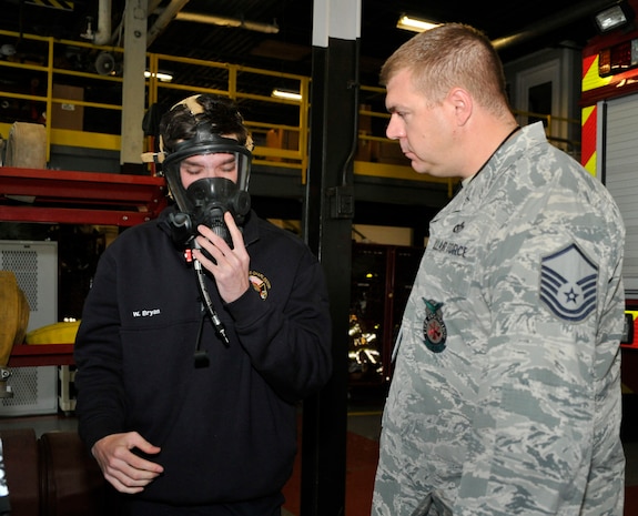 Master Sgt. Mike Kellebrew, a Unit Effectiveness Inspection fire emergency inspector, watches William Bryan, a 628th Civil Engineering Squadron firefighter testing an air tank and breathing apparatus at the Joint Base Charleston Fire Department April 13, 2016. The apparatus includes an automatic distress signal unit. A distinct alarm tone sounds if movement is not detected for a certain length of time. The alarm helps locate firefighters in distress. (U.S. Air Force Photo/Airman Megan Munoz)